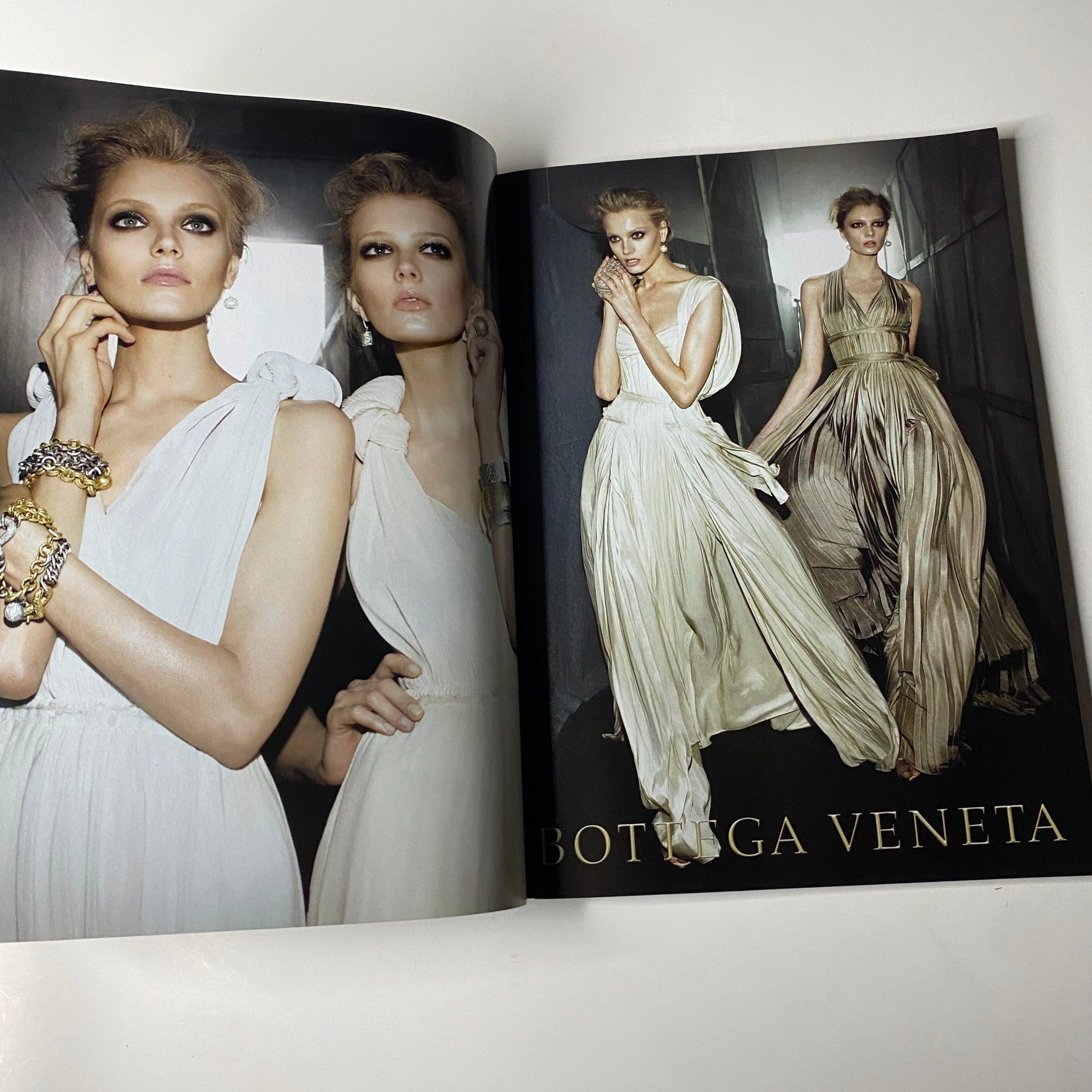 Vogue Magazine October 2009 featuring a high-fashion editorial spread by Bottega Veneta, highlighting stunning dresses on models with dramatic poses.