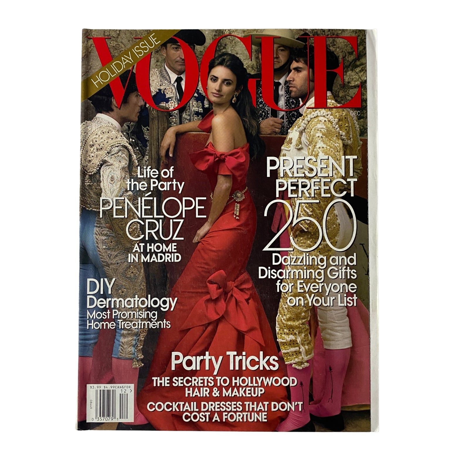 Vogue Magazine December 2007 cover featuring Penélope Cruz in a stunning red silk gown, photographed by Julian Broad. This Holiday Issue highlights gift ideas and includes a feature on Penélope Cruz's life and career.