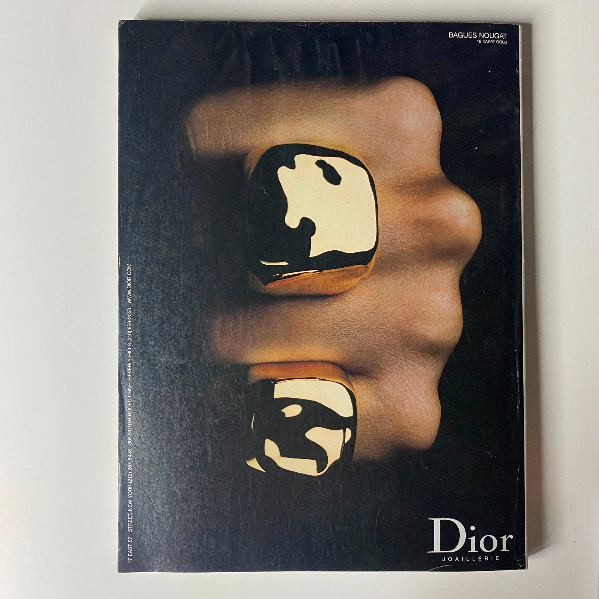 Elegant jewelry advertisement for Dior, highlighting unique golden accessories, featured in Vogue Magazine February 2003 Debra Messing Cover. This image captures luxury and sophisticated design.