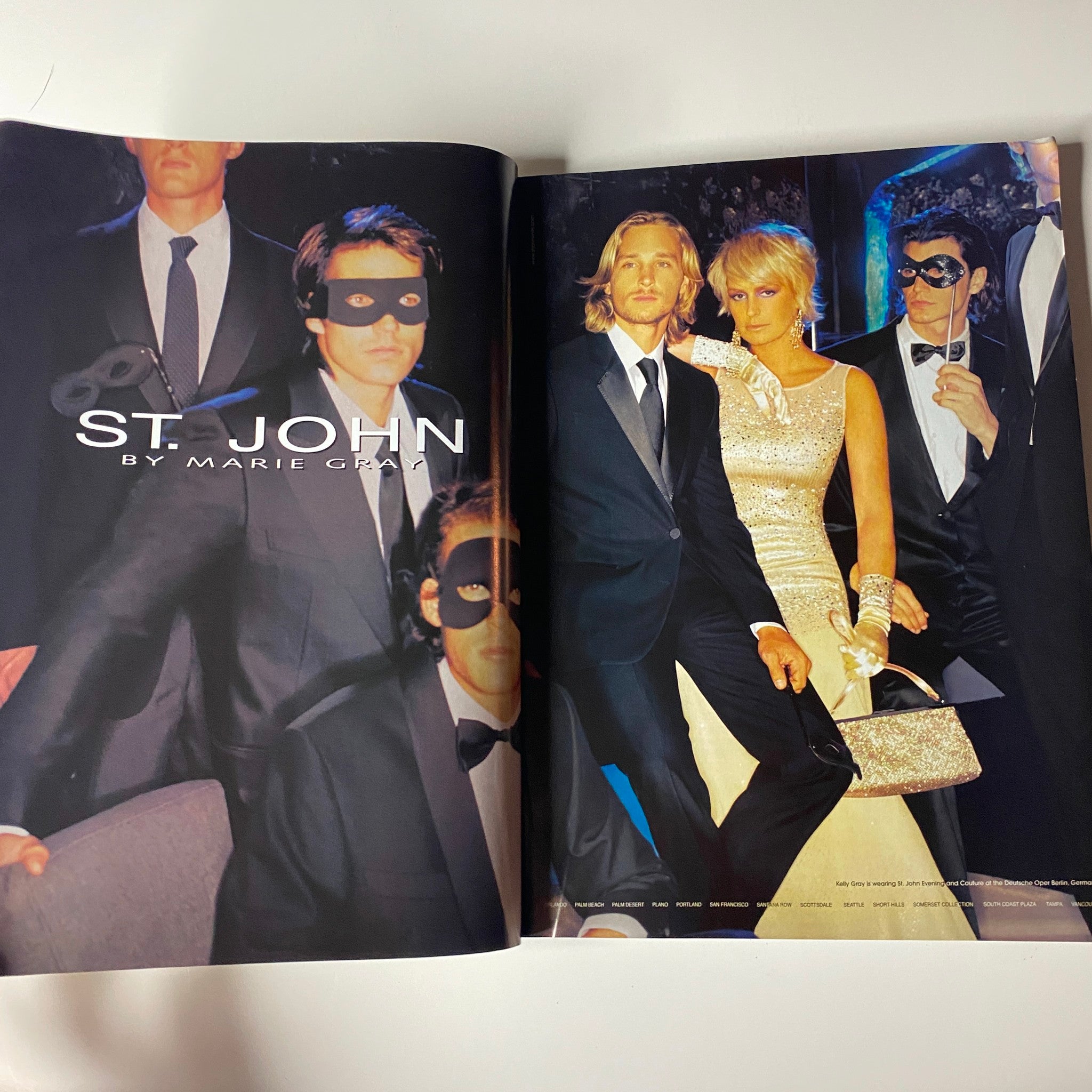 A fashion editorial spread titled 'St. John' from Vogue Magazine October 2004 Charlize Theron Cover No Label VG, featuring models in elegant attire at a masked event.