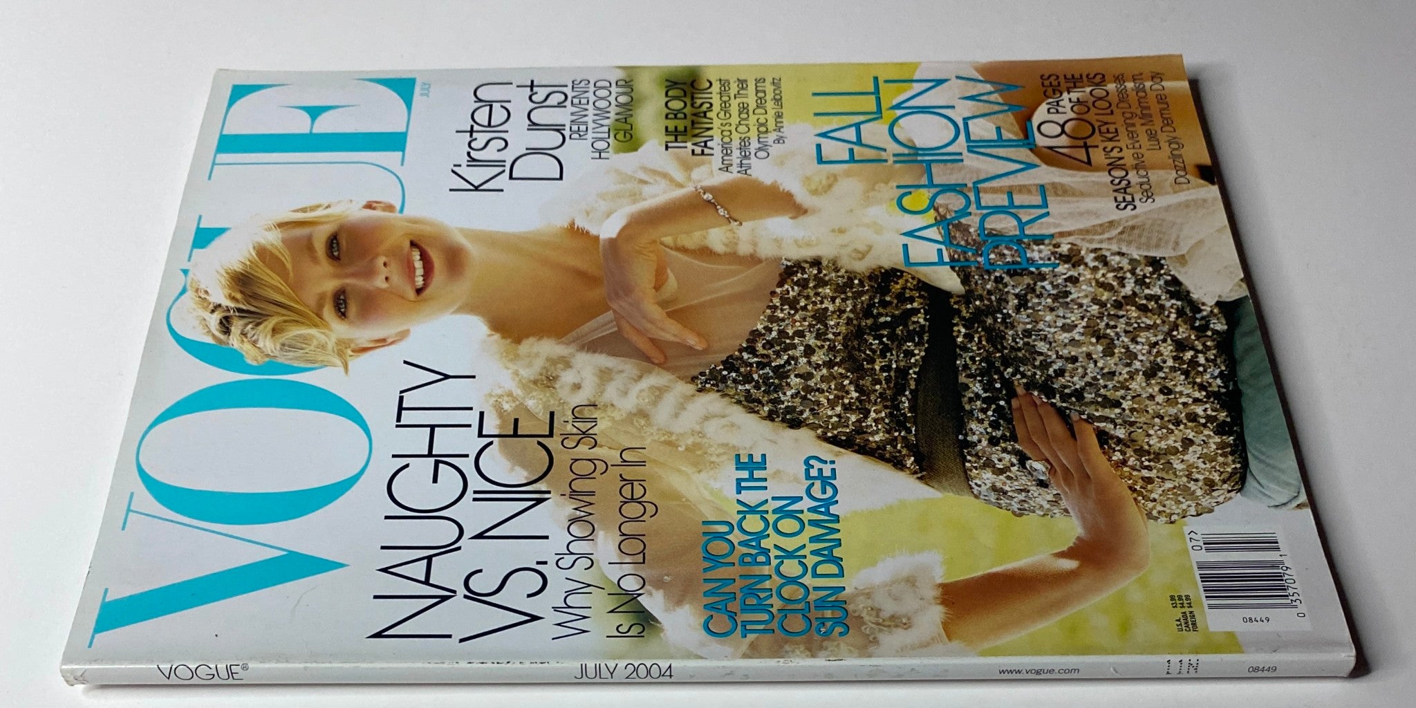 Vogue Magazine July 2004 featuring Kirsten Dunst on the cover, illustrating her stylish portrait and highlighting fashion themes of the issue.