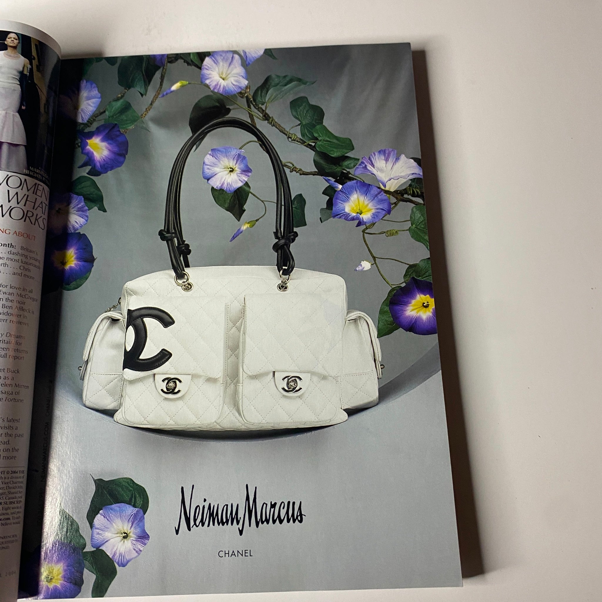 Chanel advertisement featuring a white handbag on the page of April 2004 Vogue Magazine, promoting luxury fashion with flowers in the background.