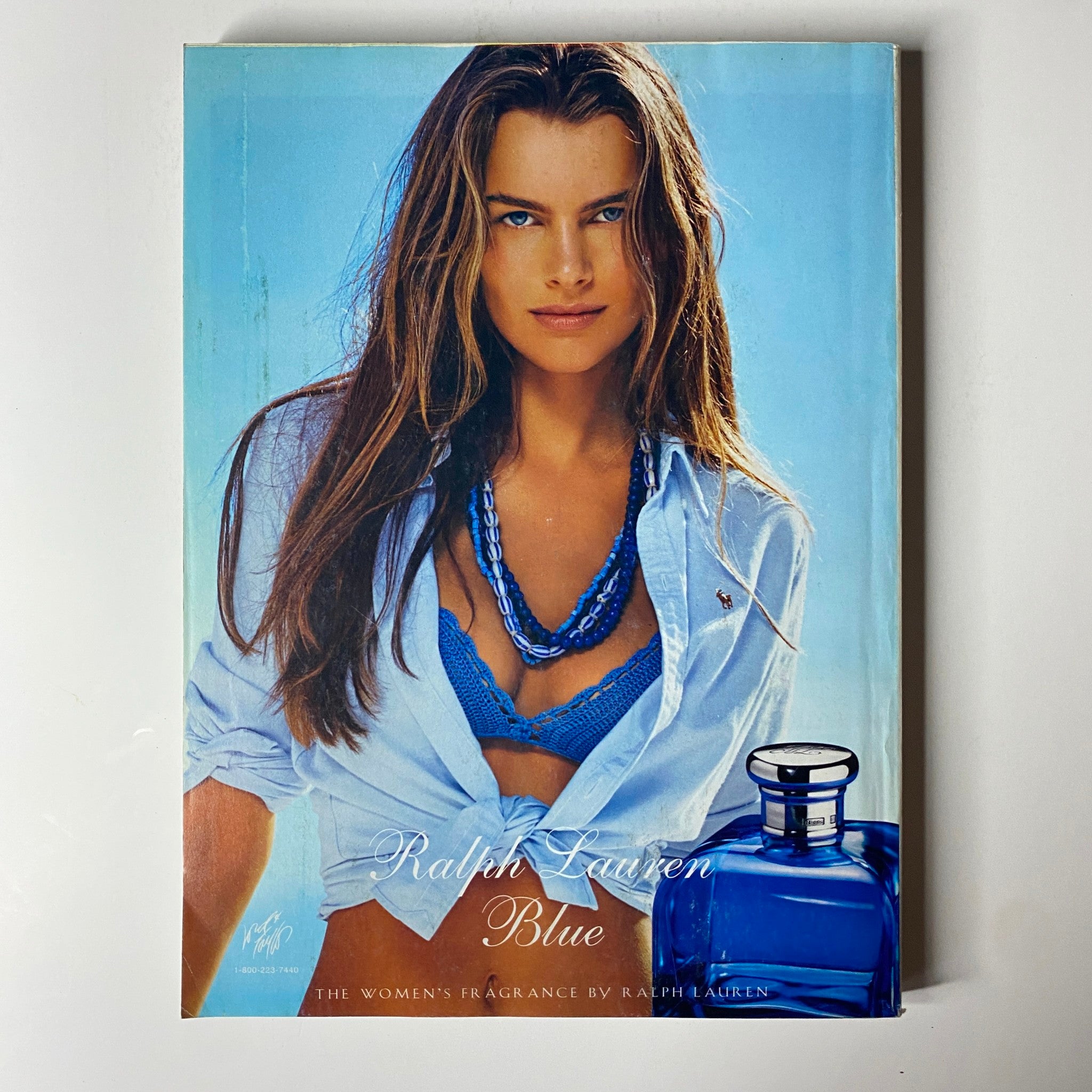 Ralph Lauren Blue fragrance advertisement featuring a model in a blue setting, showcasing the women's fragrance by Ralph Lauren in the April 2004 issue of Vogue Magazine.