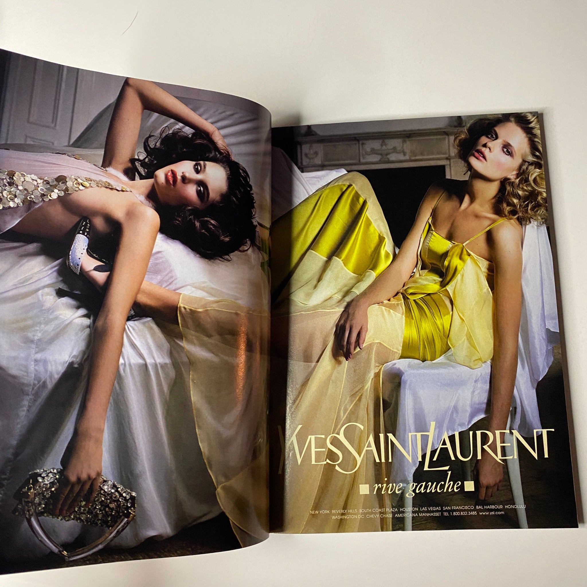 A fashion spread in Vogue Magazine February 2004 showcasing Yves Saint Laurent designs, emphasizing elegance and high fashion aesthetics.
