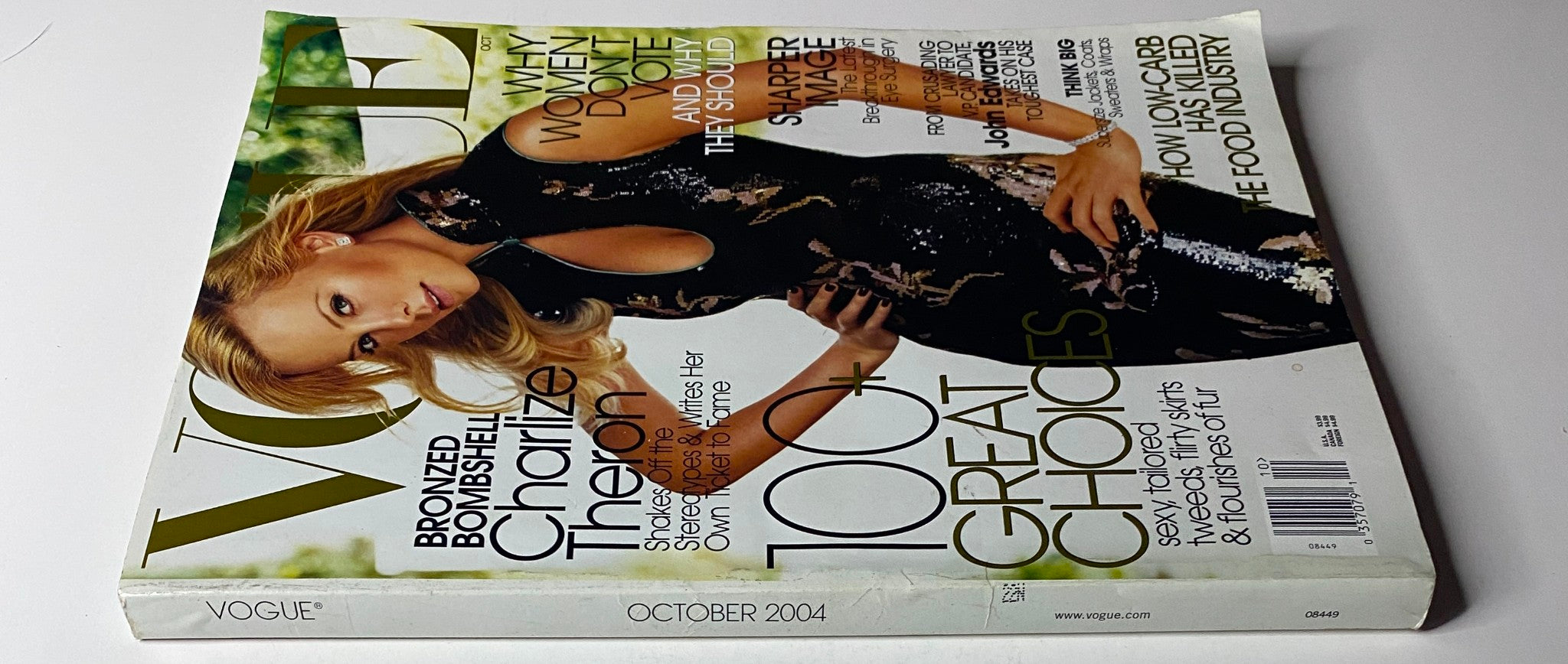 Side view of Vogue Magazine October 2004 showcasing actress Charlize Theron on the cover, emphasizing her significance in Hollywood fashion.