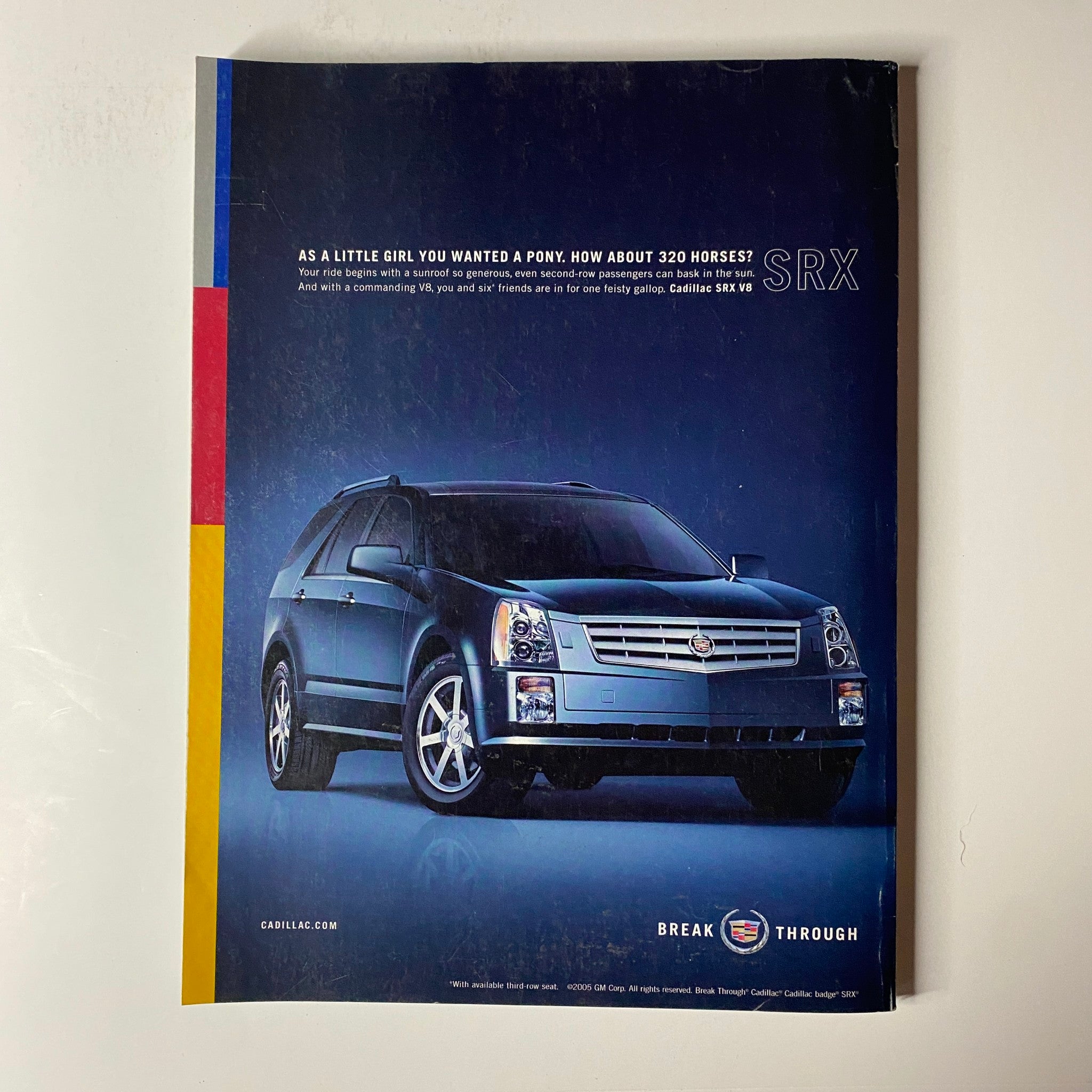 Vogue Magazine May 2005 Liya Kebede Cover No Label VG featuring an advertisement for the Cadillac SRX, highlighting its powerful performance with the tagline about horses and luxury. The ad showcases a sleek blue SUV against a minimalist background, emphasizing style and strength.