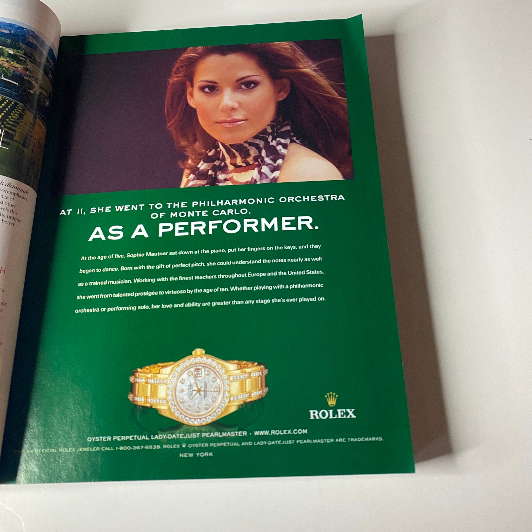 An advertisement from Vogue Magazine September 2004 for Rolex, featuring an elegant image of a performer and a luxurious watch, illustrating the intersection of music and high fashion.