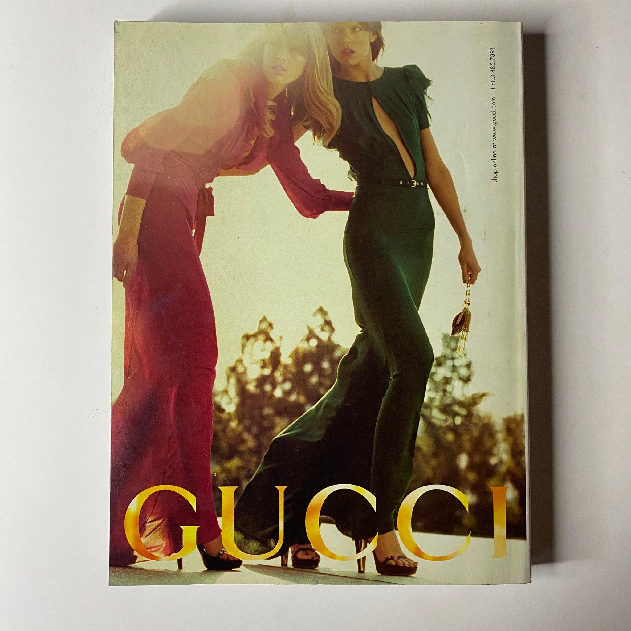 Vogue Magazine March 2006 featuring a striking Gucci advertisement showcasing elegant women in high-fashion attire, presented in very good condition.