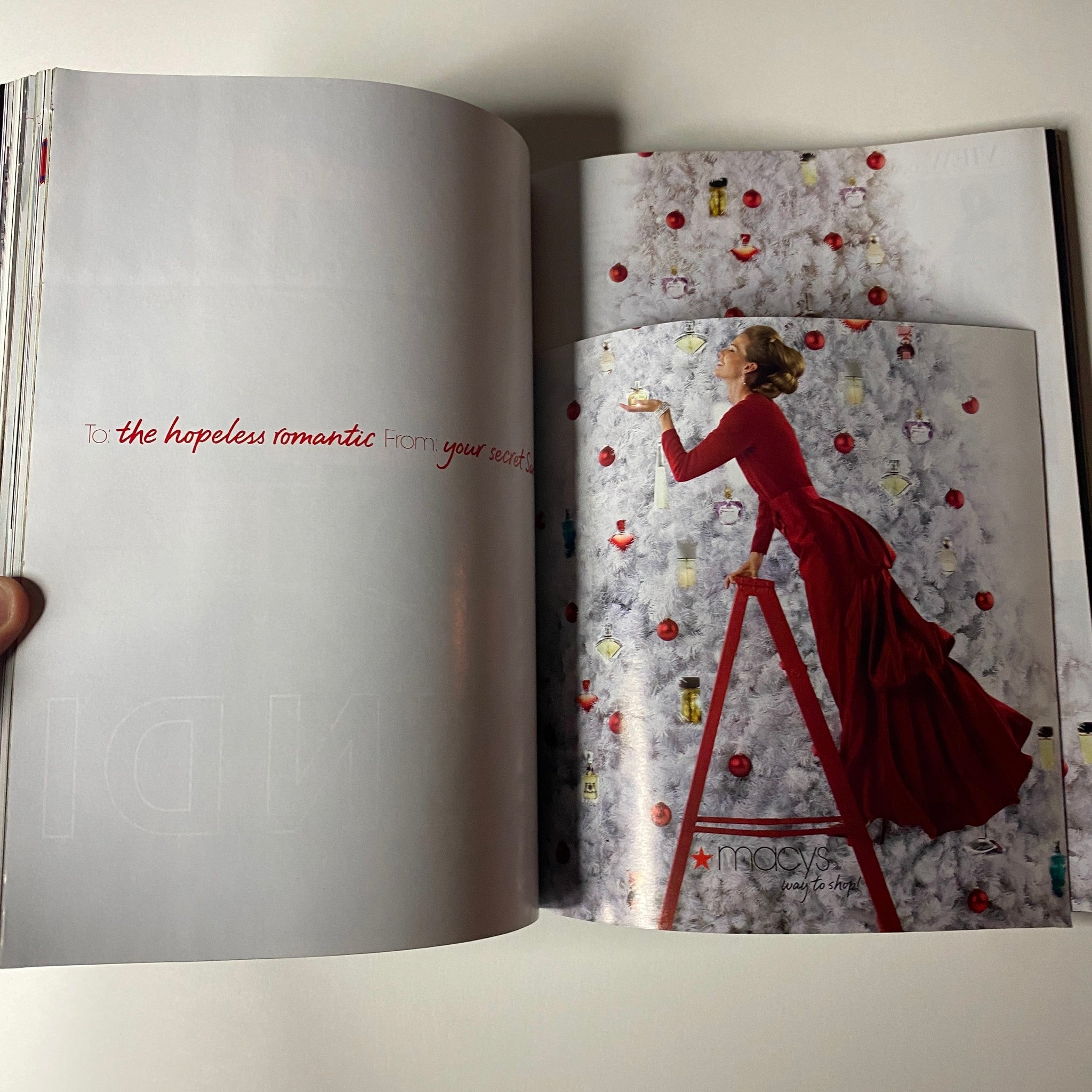Inside spread of Vogue Magazine December 2006 featuring a model in a red dress against a backdrop of snowy decor. This image complements the Nicole Kidman cover, showcasing holiday fashion themes.