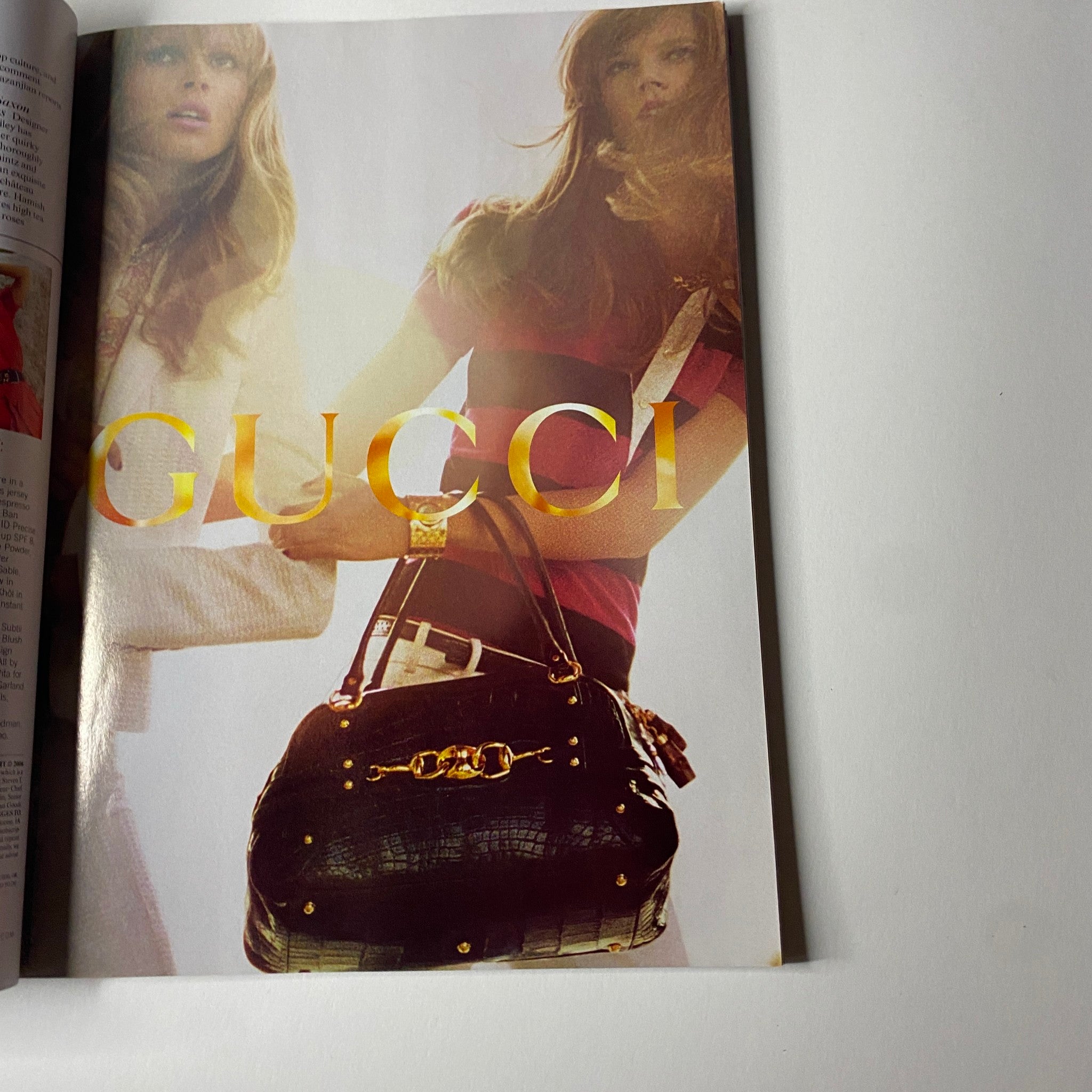 A promotional page from Vogue Magazine February 2006 featuring Gucci branding, illustrating high-end fashion accessory trends popular in the mid-2000s.