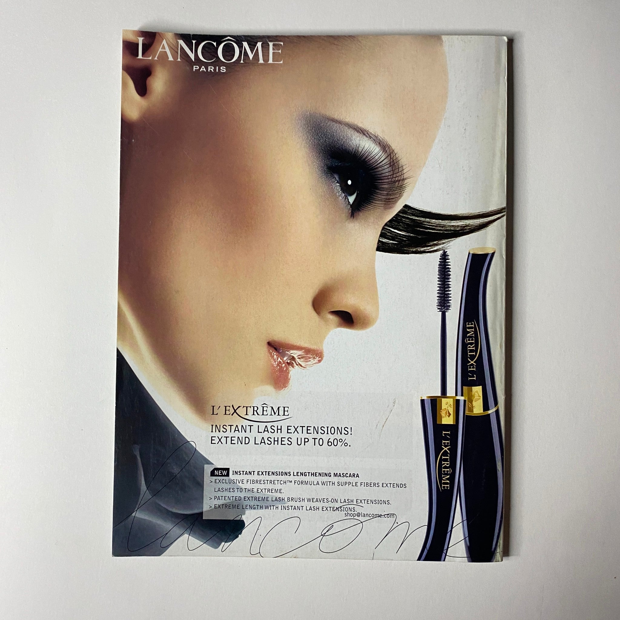 Advertisement from Vogue Magazine January 2006 for Lancôme L'Extrême, showcasing mascara and the dramatic eye look it creates, emphasizing beauty and allure.