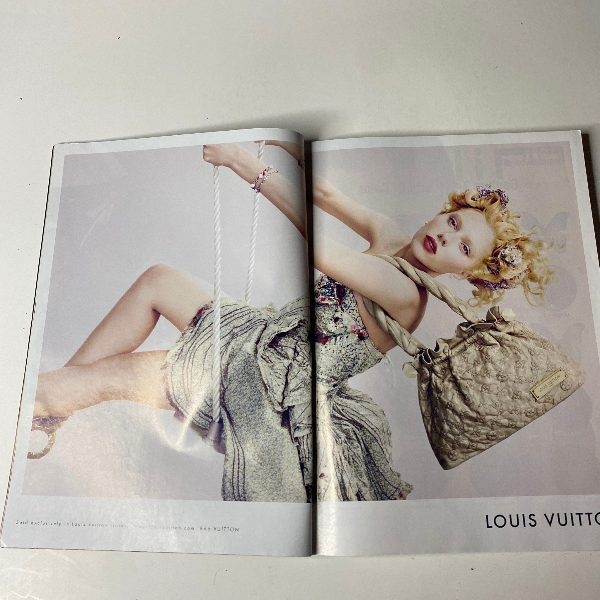 Double-page spread from Vogue Magazine June 2007 featuring a Louis Vuitton advertisement with a model showcasing fashion designs.