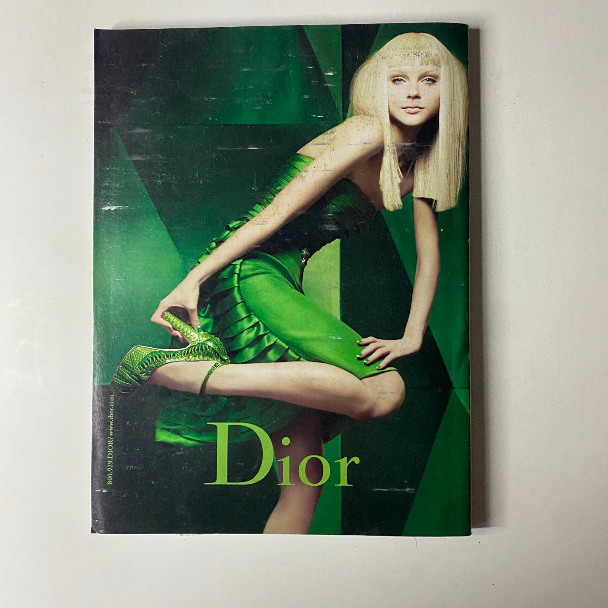 Cover of Dior magazine featuring a model in a striking green dress, exuding a sense of high fashion and sophisticated style, representative of contemporary trends in Vogue Magazine August 2007.