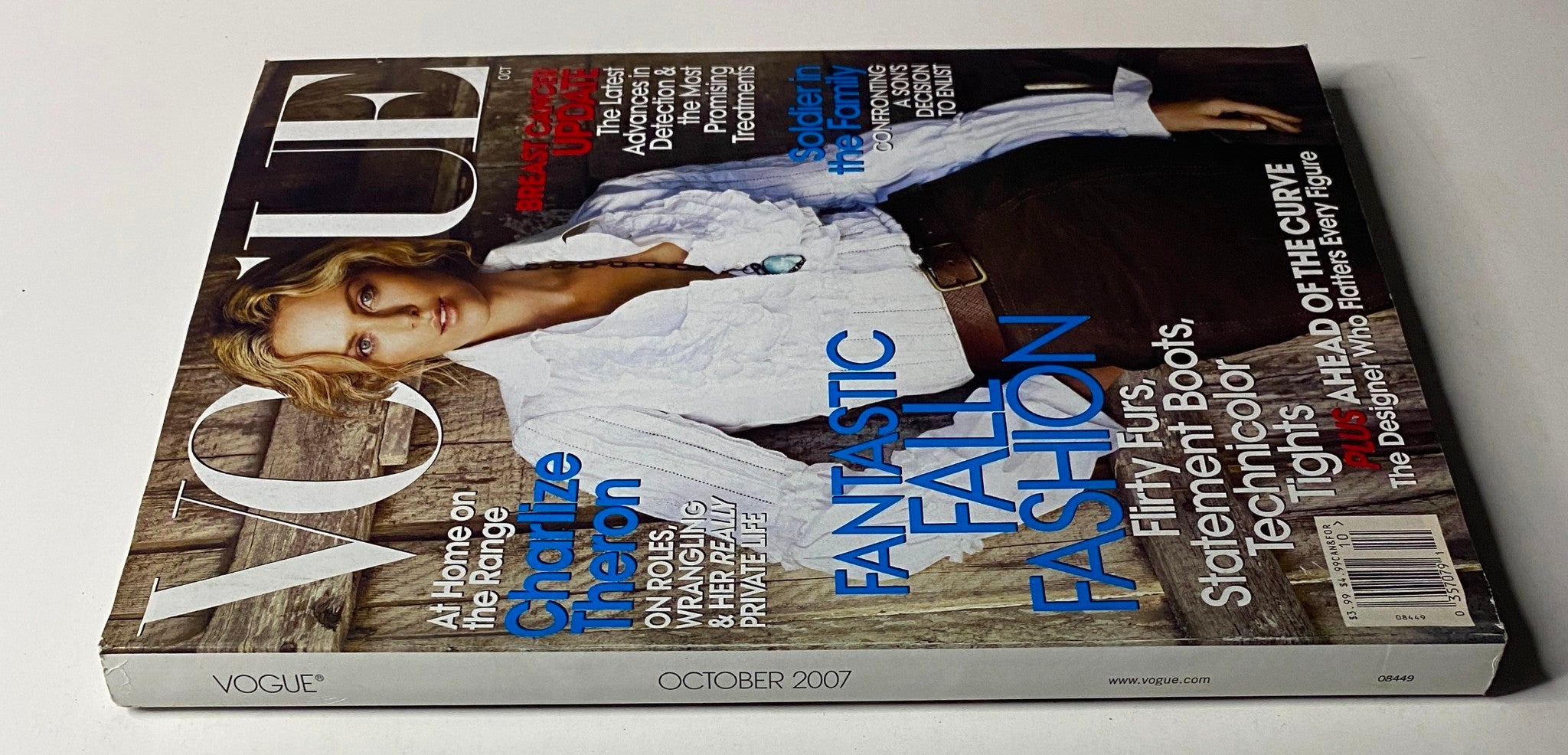 Close-up view of Vogue Magazine October 2007 cover with Charlize Theron, showcasing the latest trends in Fantastic Fall Fashion, alongside a breast cancer update.