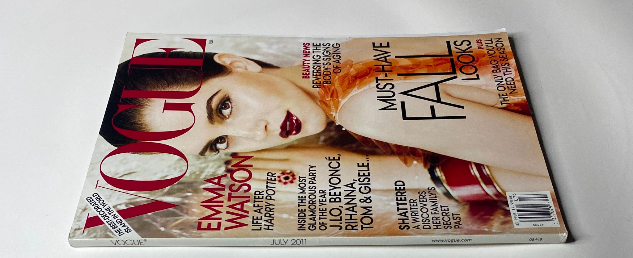 Close-up view of Vogue Magazine July 2011 cover with Emma Watson, showcasing her beauty and style after Harry Potter, featuring headlines on must-have fall looks.