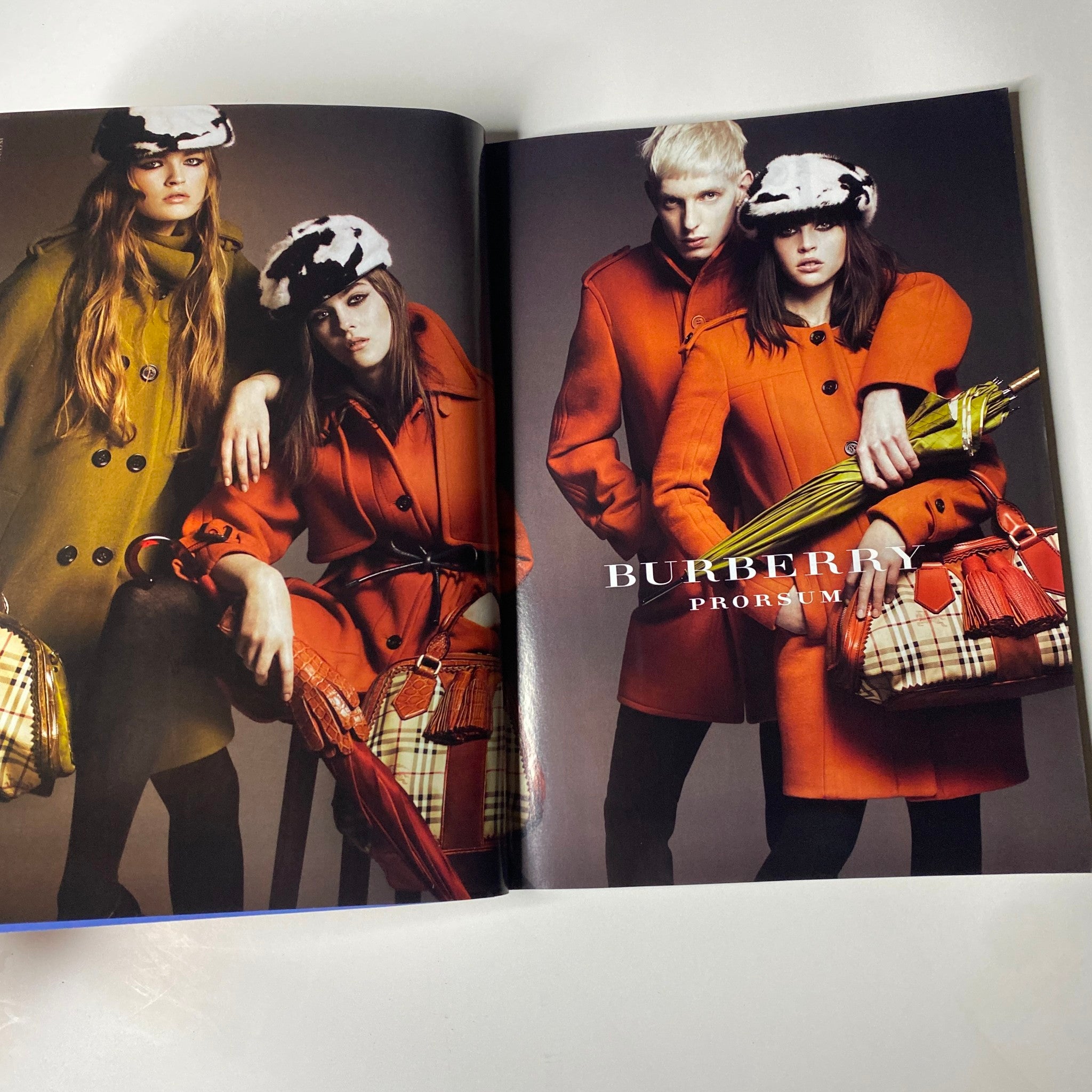 Vogue Magazine July 2011 Emma Watson Cover No Label VG featuring three models in Burberry coats, showcasing high-fashion styles for a chic editorial spread.