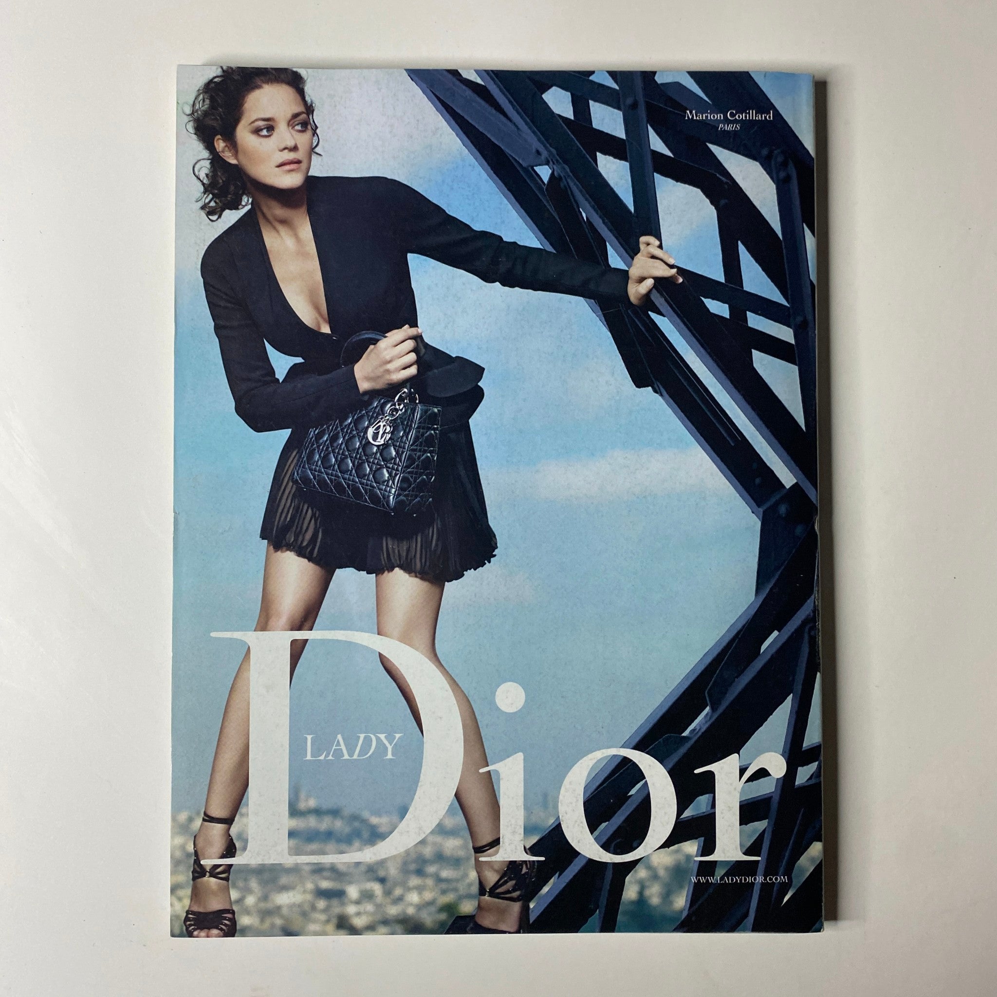 Vogue Magazine February 2009 Blake Lively Cover presenting a stylish image of a model in a black outfit with a Lady Dior handbag, emphasizing high-fashion aesthetics.
