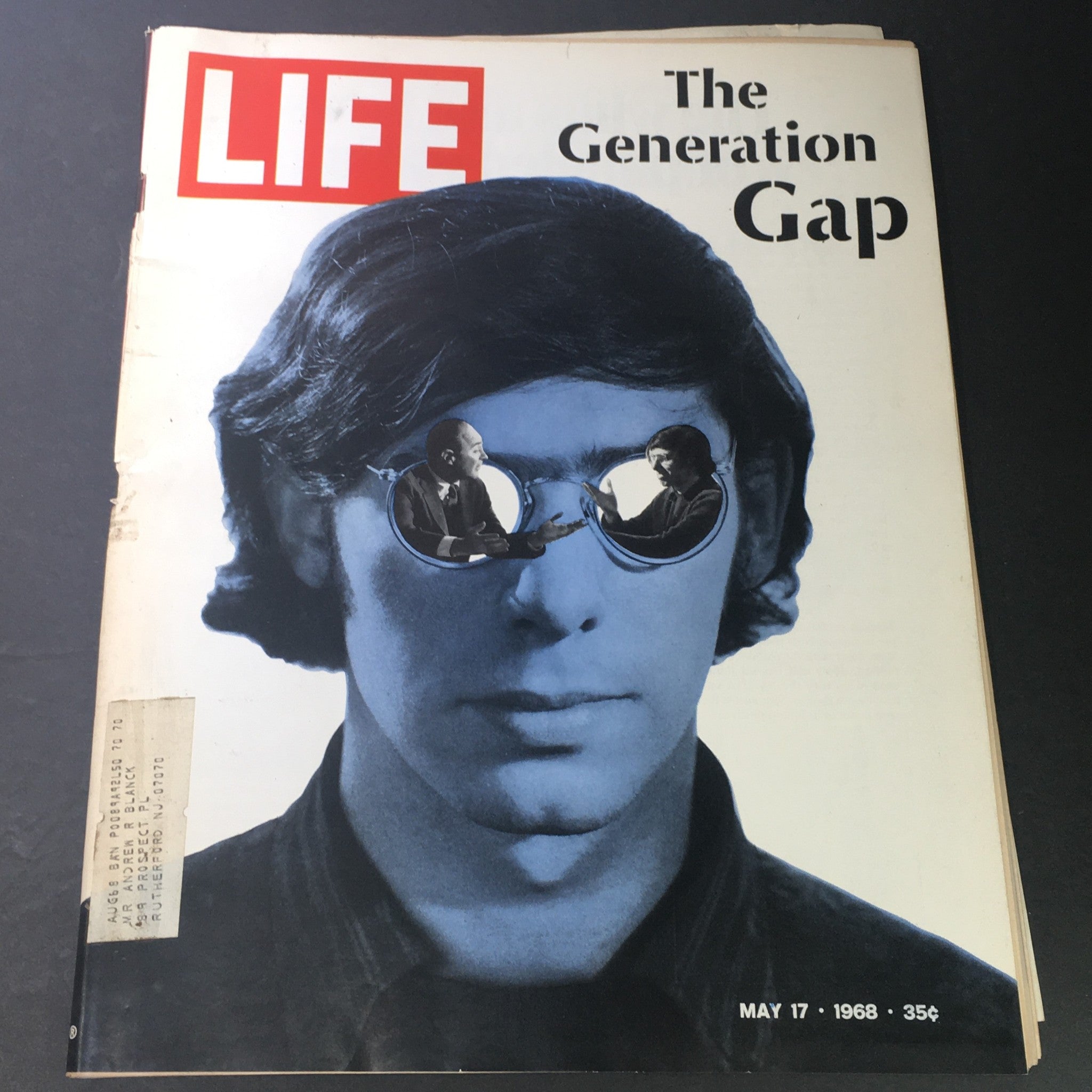 Cover of VTG Life Magazine dated May 17, 1968, showcasing the theme 'The Generation Gap' with a striking image of a young man wearing sunglasses that reflect scenes of discussion, emphasizing the cultural shifts of the era, including the influences of Bobby Kennedy and the Vietnam War.