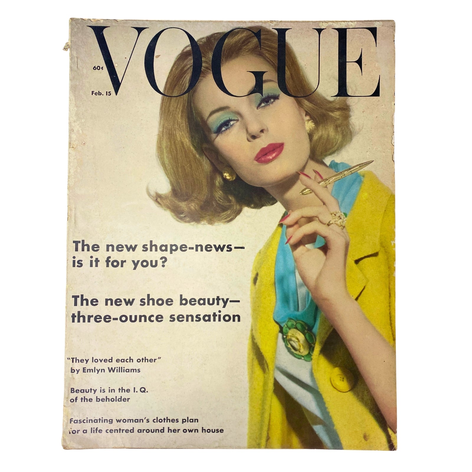 Vogue Magazine cover from February 15, 1962 featuring a model in a yellow outfit and stylish hair, highlighting fashion trends with the title 'The new shape-news – is it for you?' and 'The new shoe beauty – three-ounce sensation.' The issue showcases mid-century fashion and cultural articles.