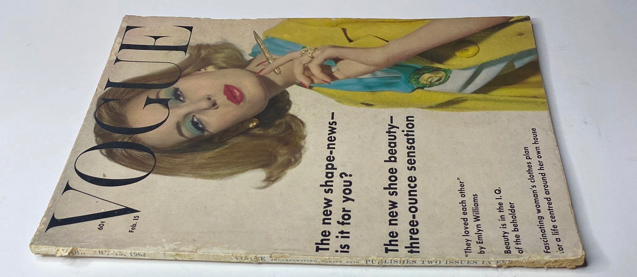 Cover of Vogue Magazine – February 15, 1962 featuring a model wearing stylish jewelry and makeup, presenting a fashion trend of the early 1960s, highlighting the issue's theme.