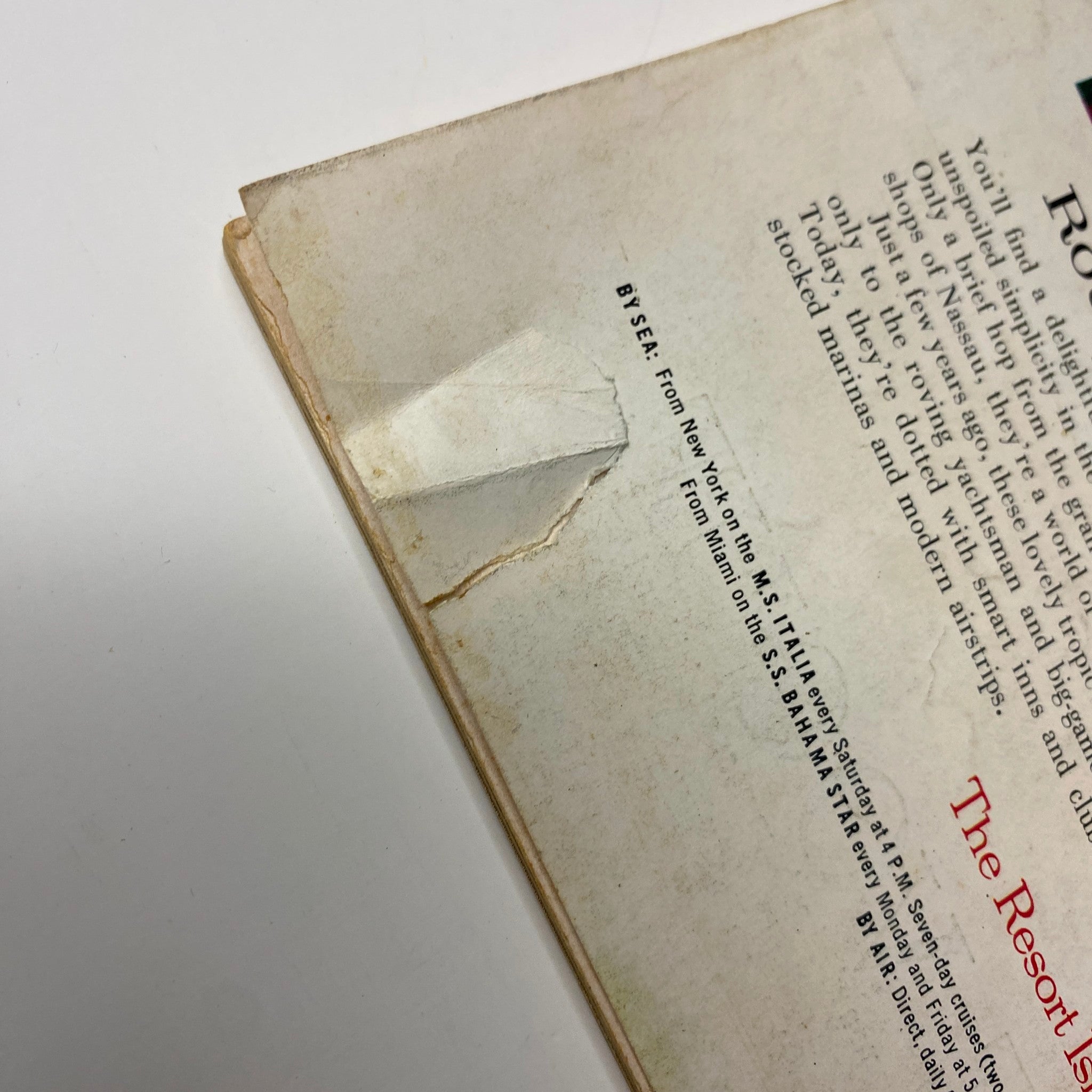 Detail of damage on the back cover of Vogue Magazine – February 15, 1962, highlighting wear that reflects the magazine's vintage status and history.