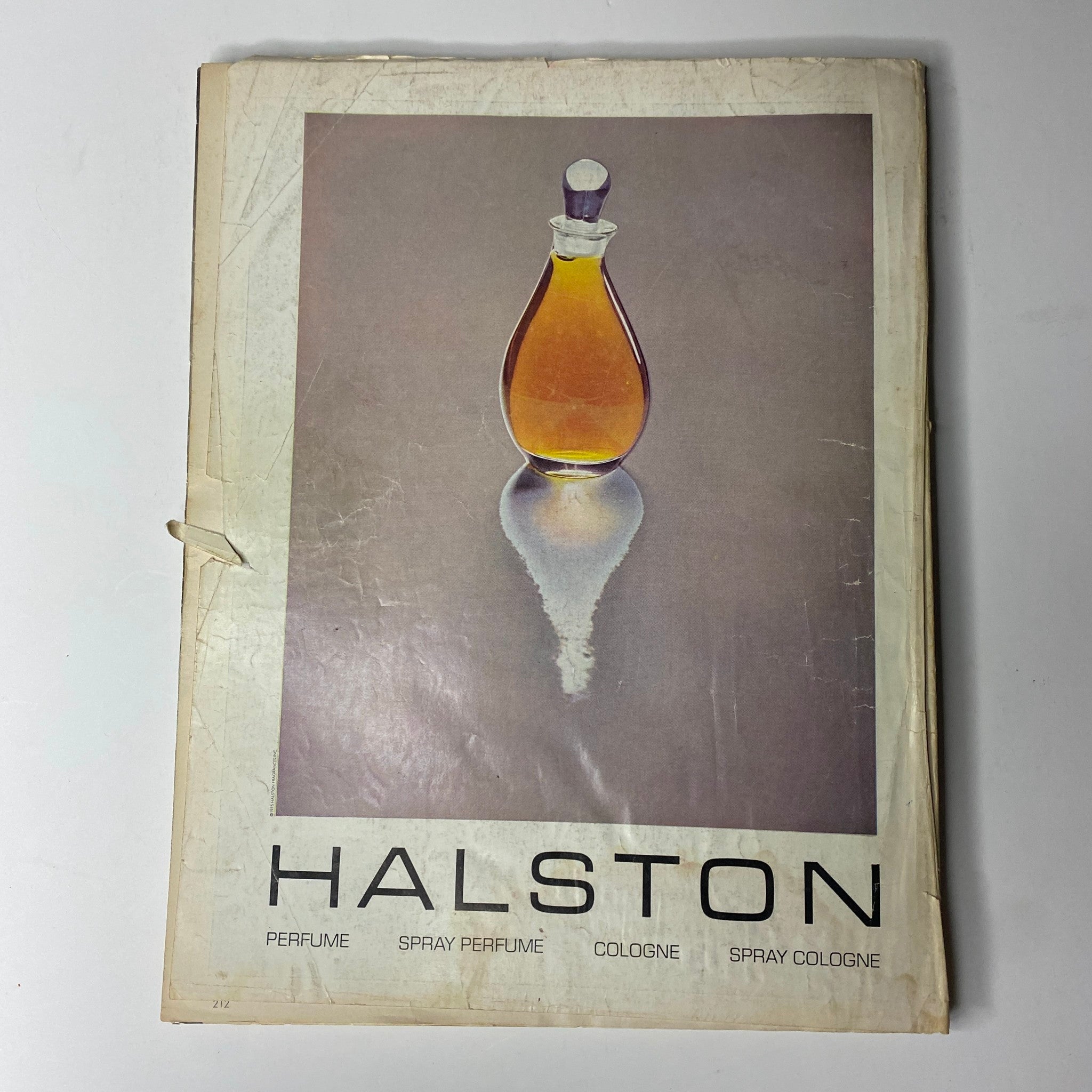 Back cover of Vogue Magazine May 1976 displaying a stylish Halston perfume advertisement, emphasizing the elegance of 1970s fragrance design.