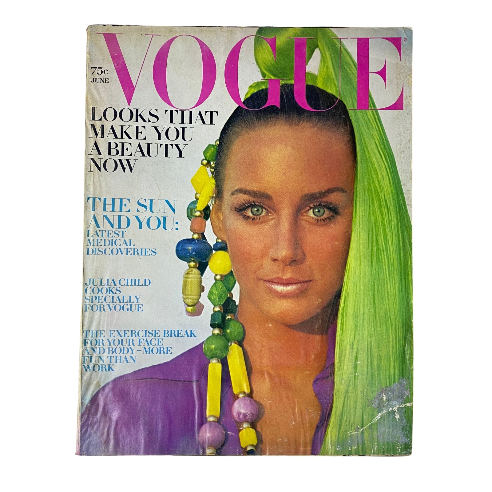 Vogue Magazine June 1969 featuring a cover image of a model with long green hair and colorful accessories, showcasing the theme 'Looks That Make You a Beauty Now'.