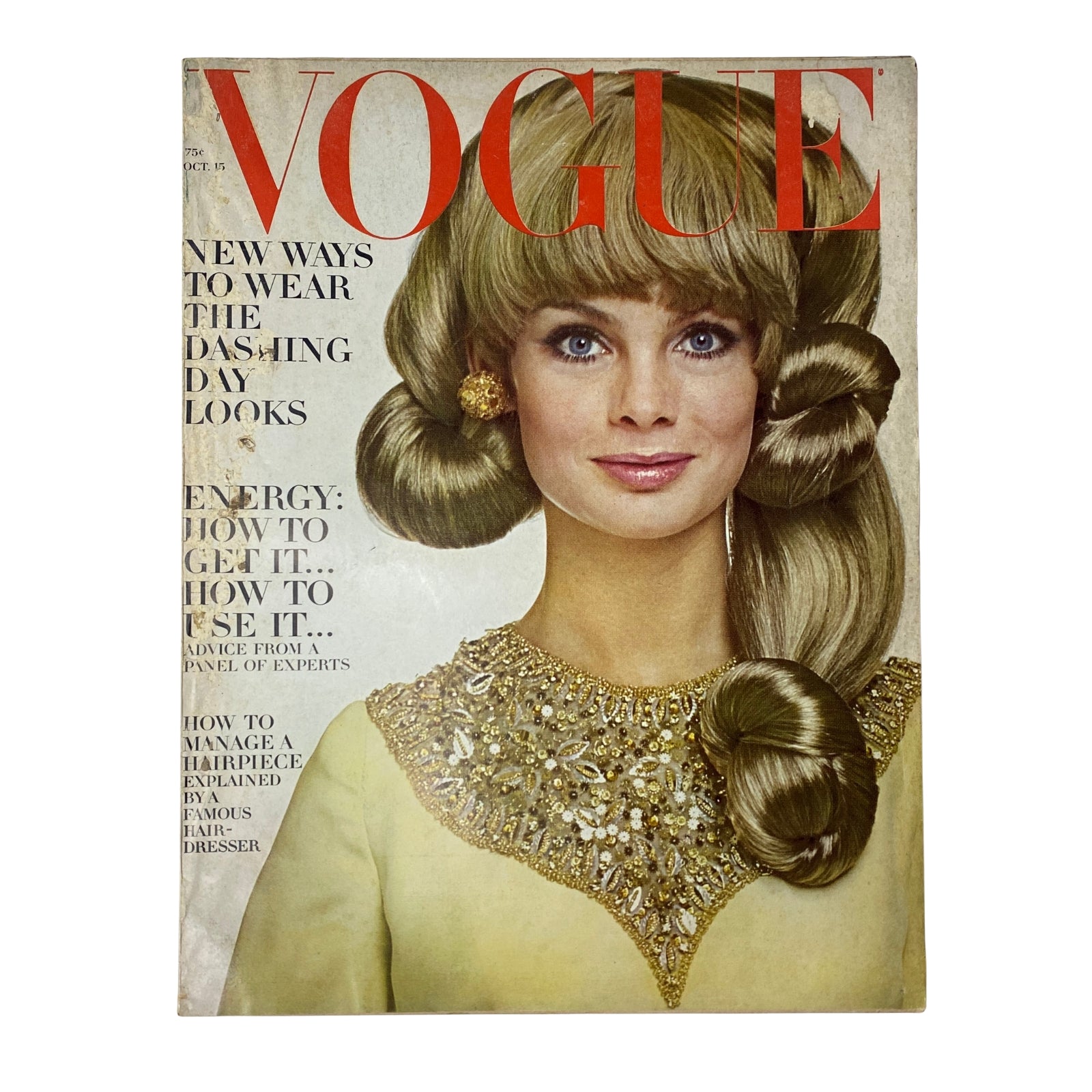 Vogue Magazine October 15, 1966 featuring a model with long blonde hair styled in curls, wearing a sparkling embellished dress, showcasing beauty trends of the 1960s.