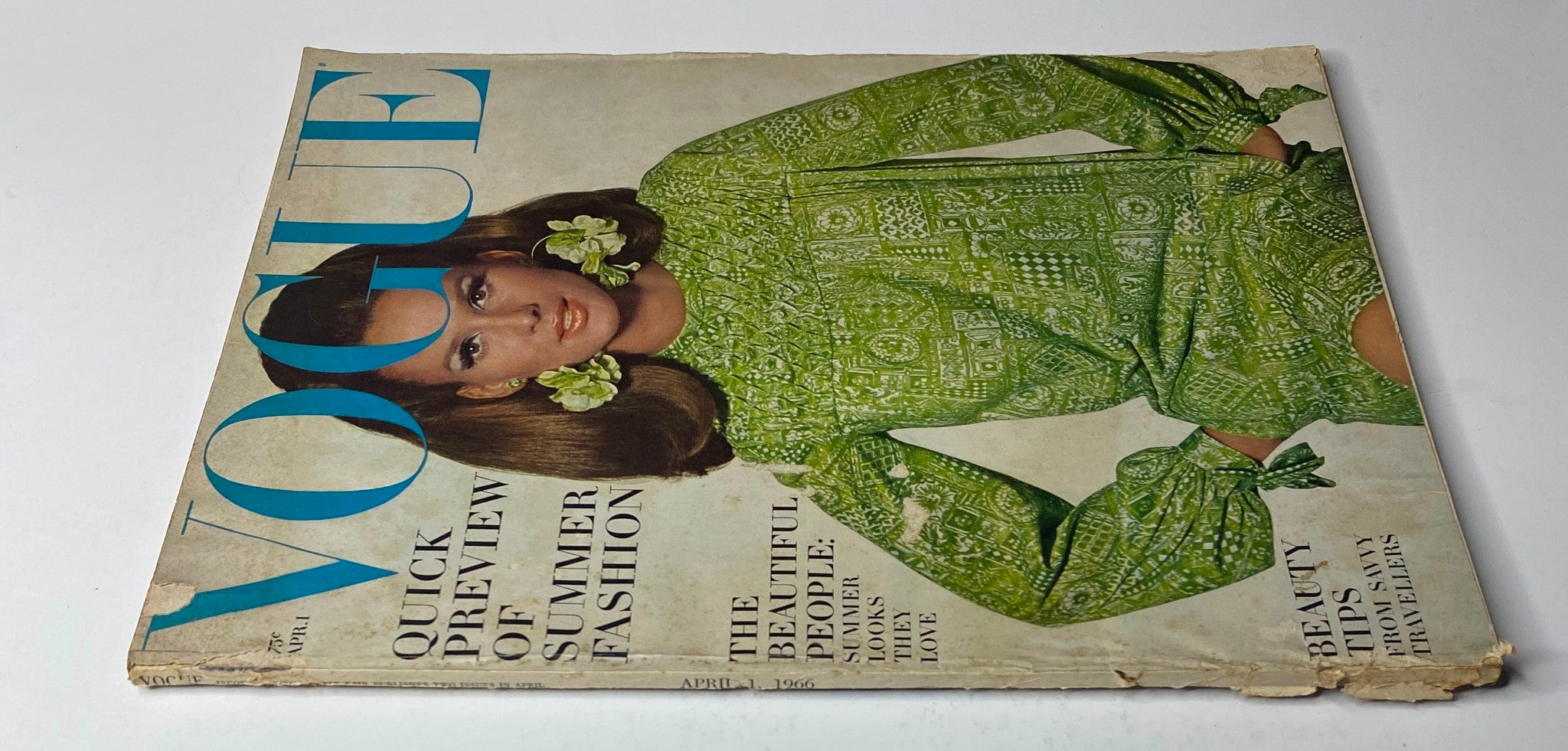 Vogue Magazine April 1, 1966 cover image displaying Brigitte Bauer in a green summer dress, emphasizing fashion trends and beauty tips.