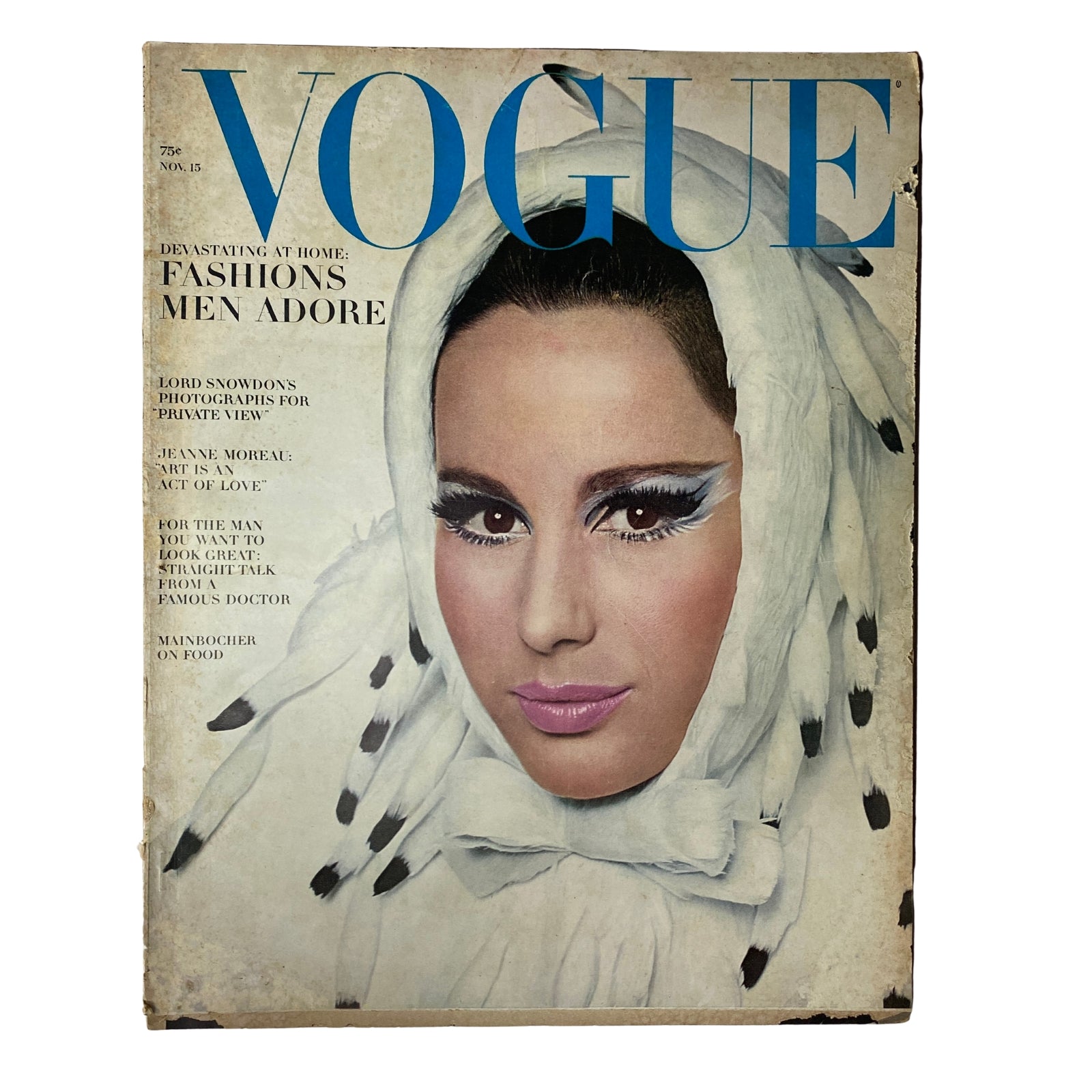 Vogue Magazine November 15, 1965 featuring cover model Brigitte Bauer, showcasing dramatic makeup with bold eyeliner, wearing a unique headscarf, capturing the essence of mid-1960s fashion trends.