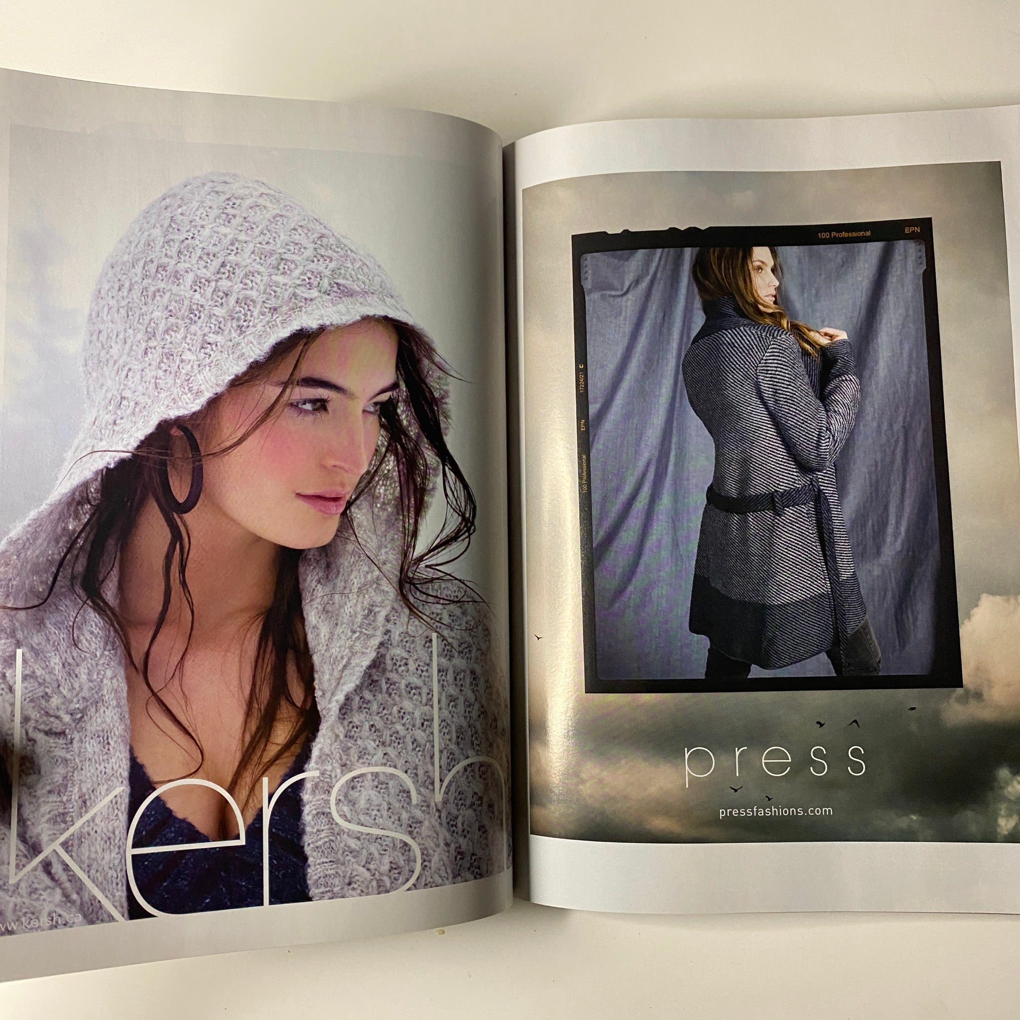 Inside view of Vogue Magazine September 2009 displaying a fashion spread with a model in a knitted hooded coat, promoting fall styles and trends as featured in the magazine.