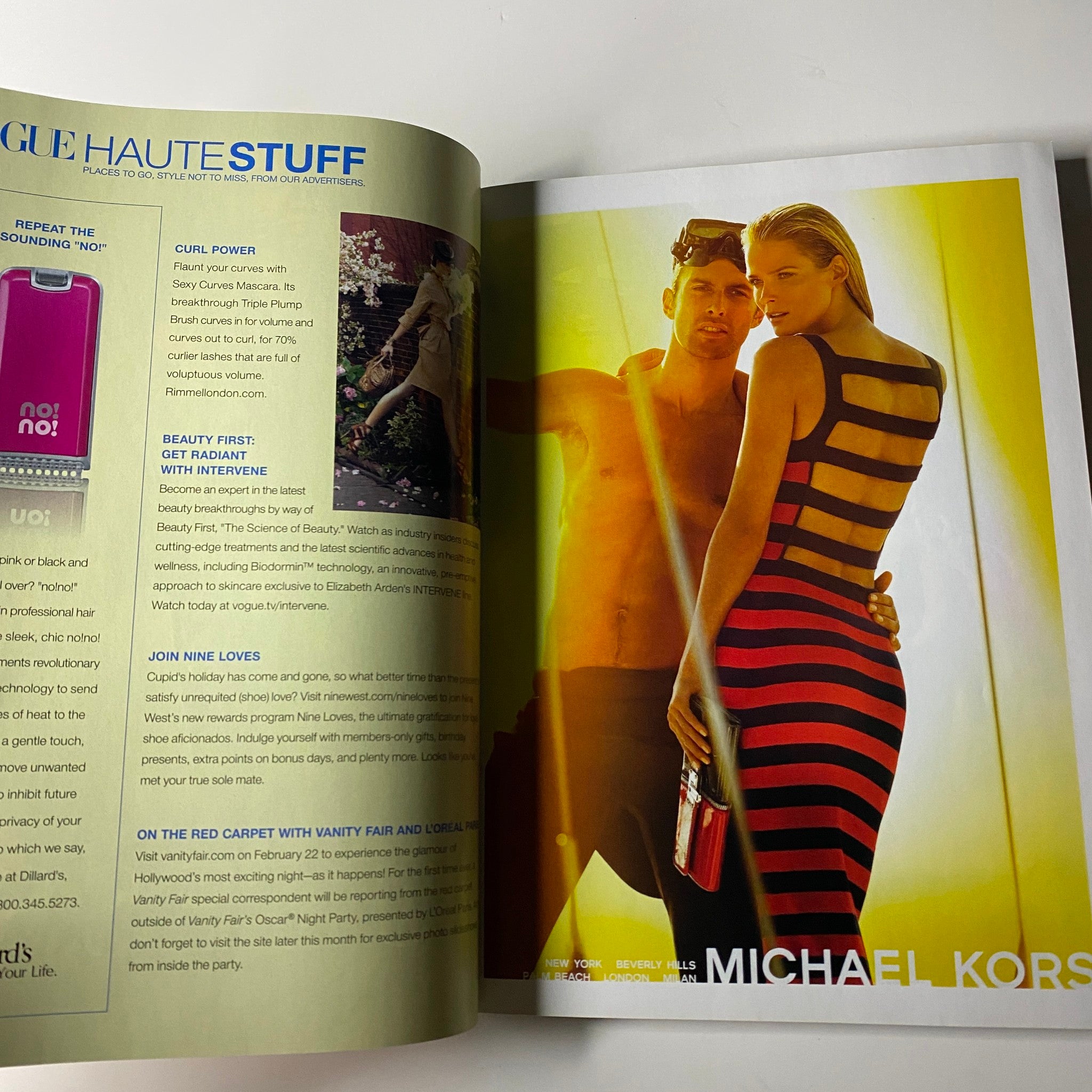A fashion advertisement from Vogue Magazine March 2009 featuring Michael Kors with a striking image of a model in a bold striped dress.