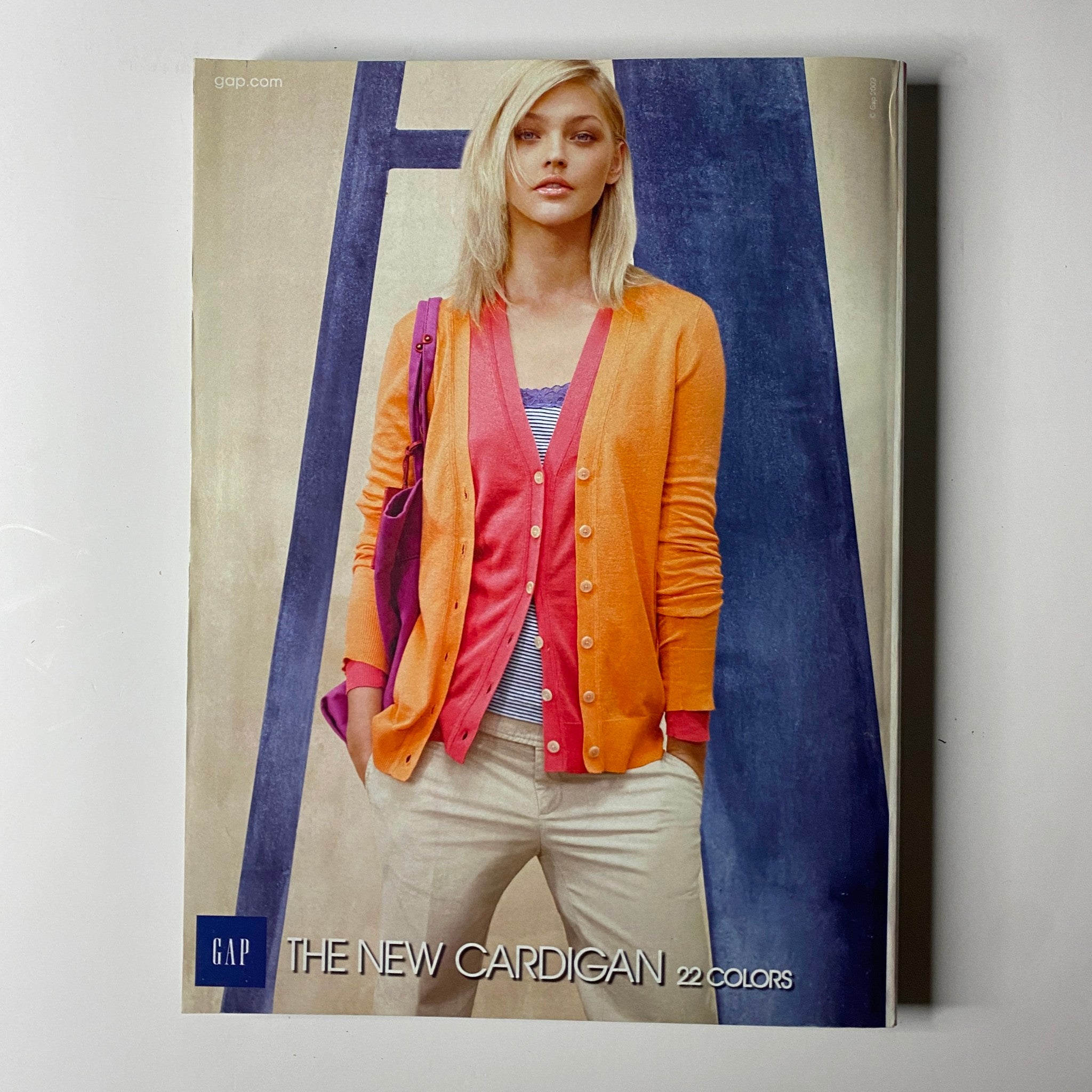 Cover page of a Gap catalog showcasing a model in a vibrant new cardigan, complementing the style trends featured in Vogue Magazine March 2009.