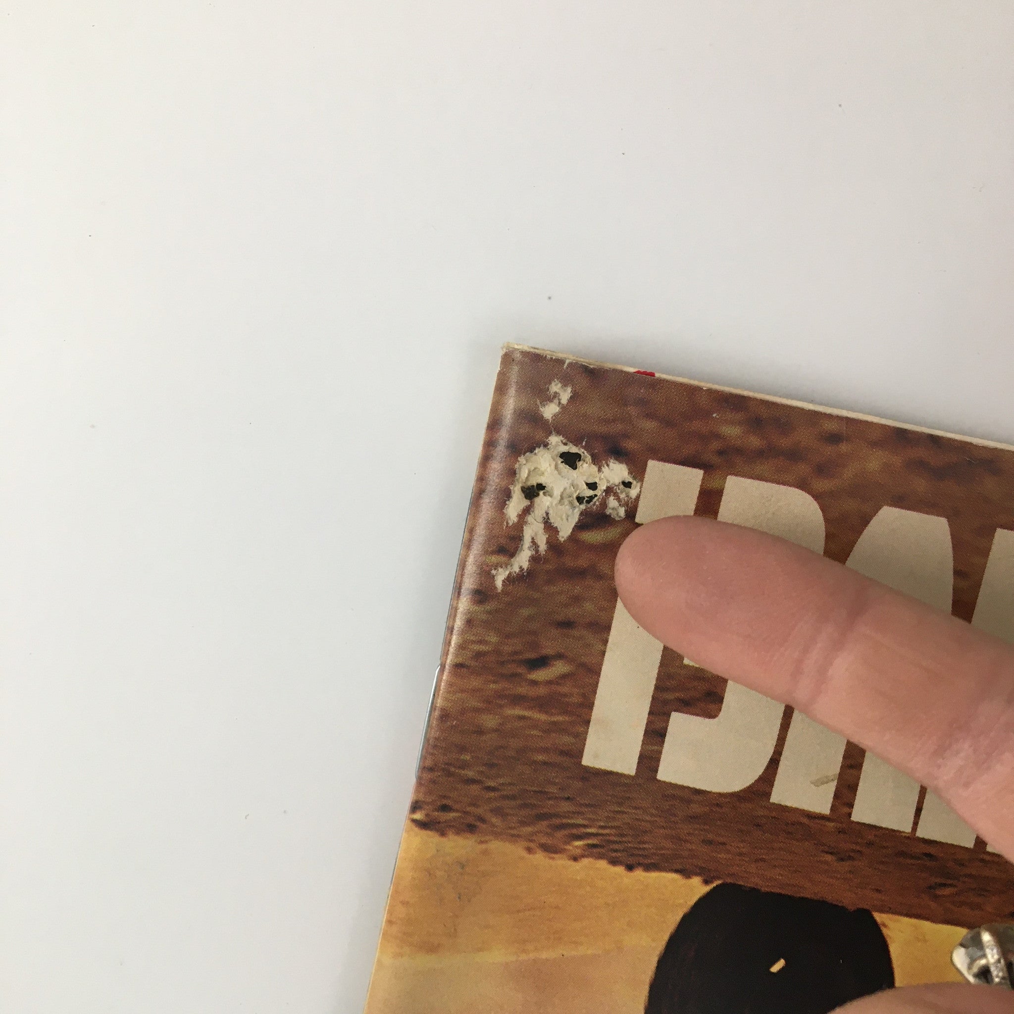 Close-up of wear on the cover of Sports Illustrated Magazine December 10 1984, highlighting minor damage that adds to its vintage appeal.
