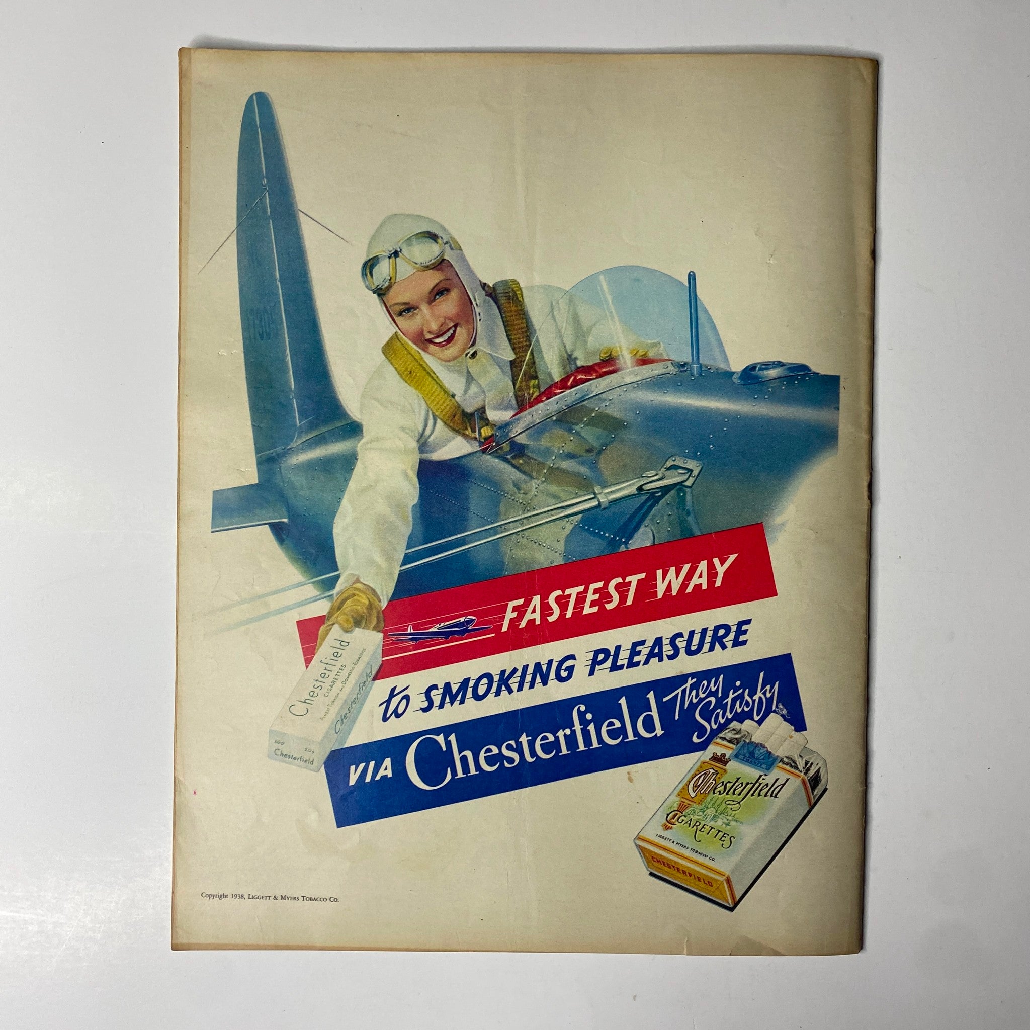 Advertisement from Look Magazine, August 30, 1938, promoting Chesterfield cigarettes, featuring a smiling female pilot holding a cigarette with a vintage aircraft background, conveying the thrill of aviation and smoking culture.