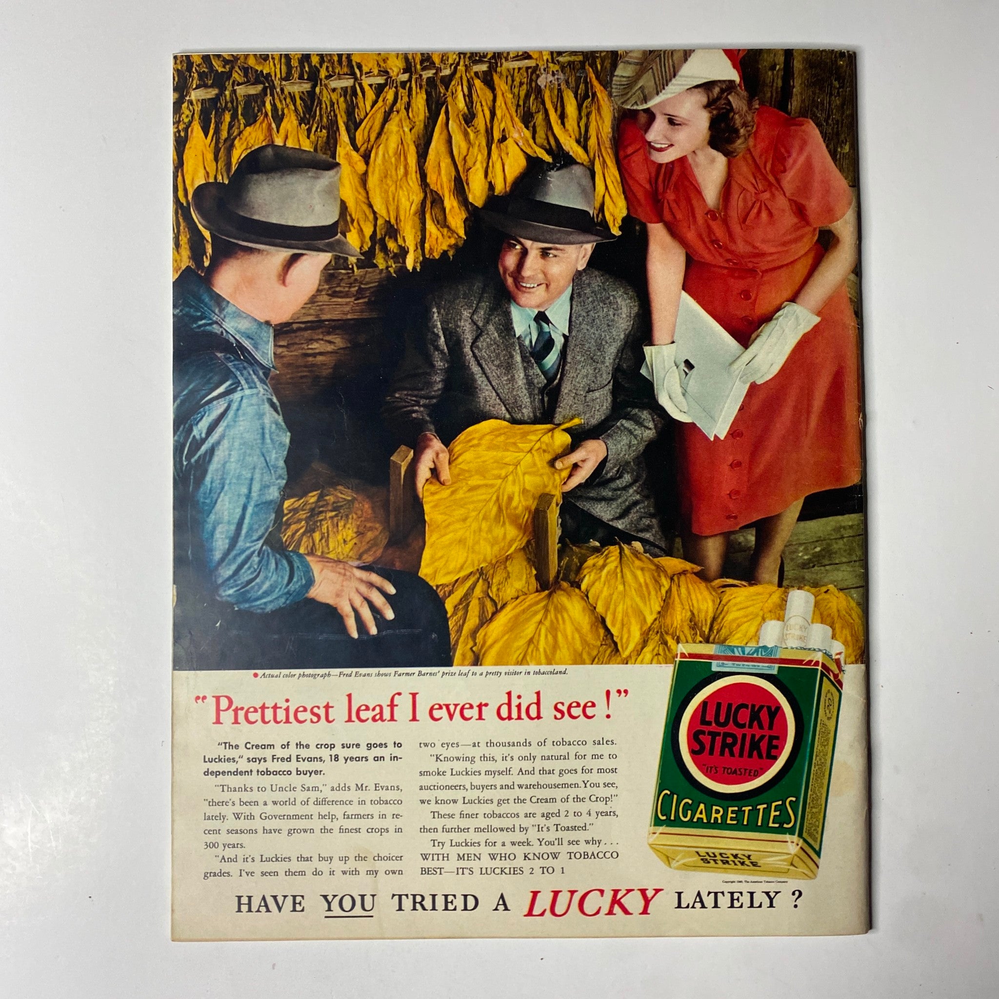 Advertisement from Look Magazine June 18, 1940, depicting two men and a woman discussing tobacco leaves, promoting Lucky Strike cigarettes.