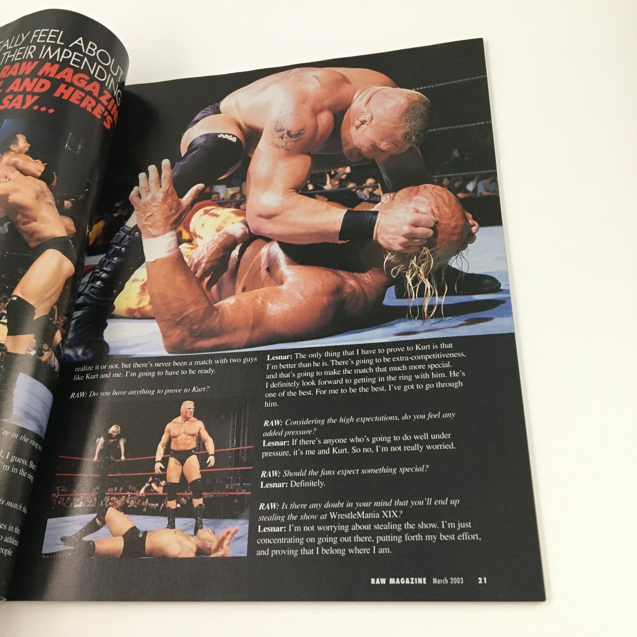Inside page of WWE Raw Magazine March 2003 displaying a wrestling match with Stone Cold Steve Austin executing a move on Hulk Hogan, highlighting their intense rivalry.