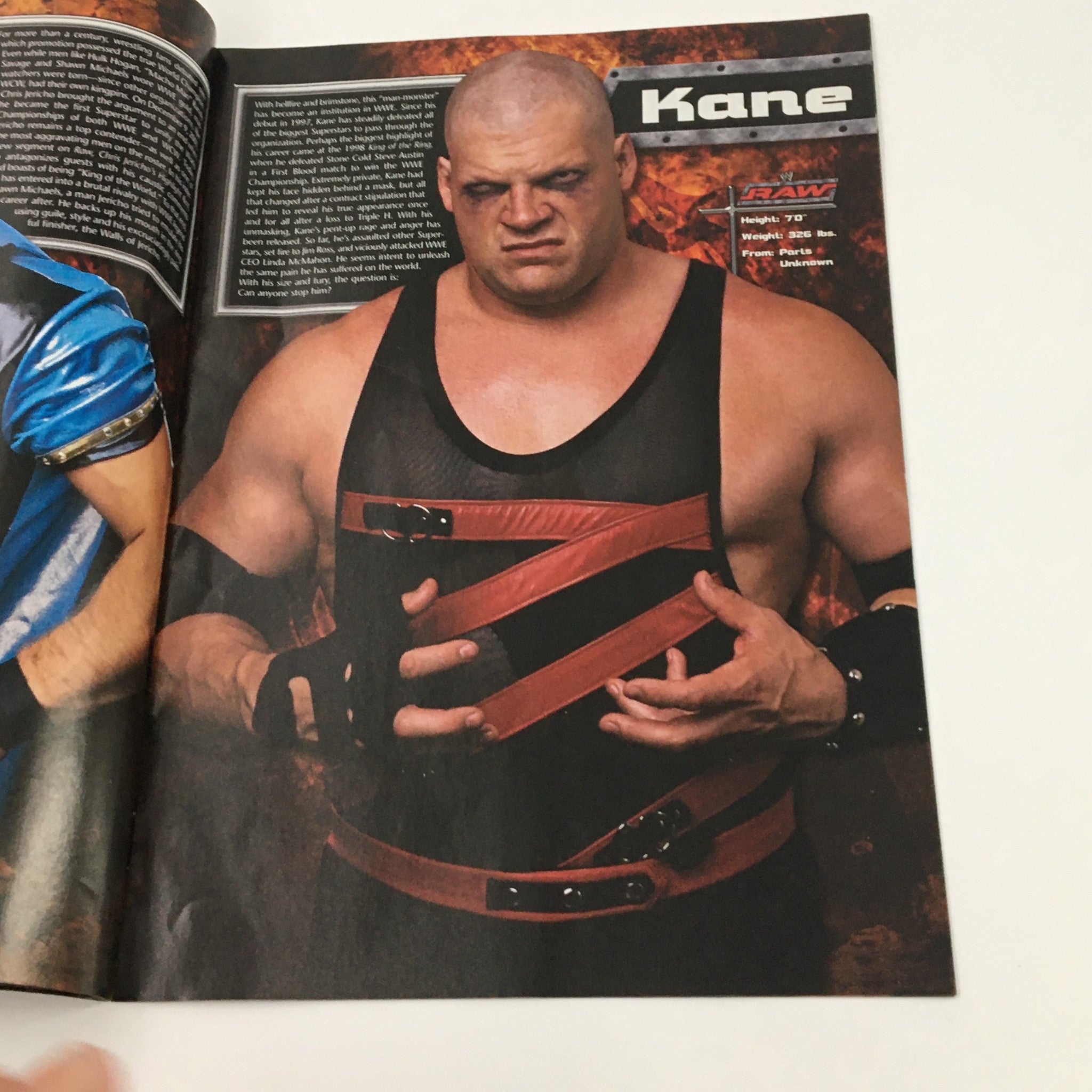 Interior page of WWE Raw Magazine 2003 featuring Kane, showcasing the professional wrestler's fierce persona and character within WWE. This page highlights Kane's role and his legacy in wrestling history.