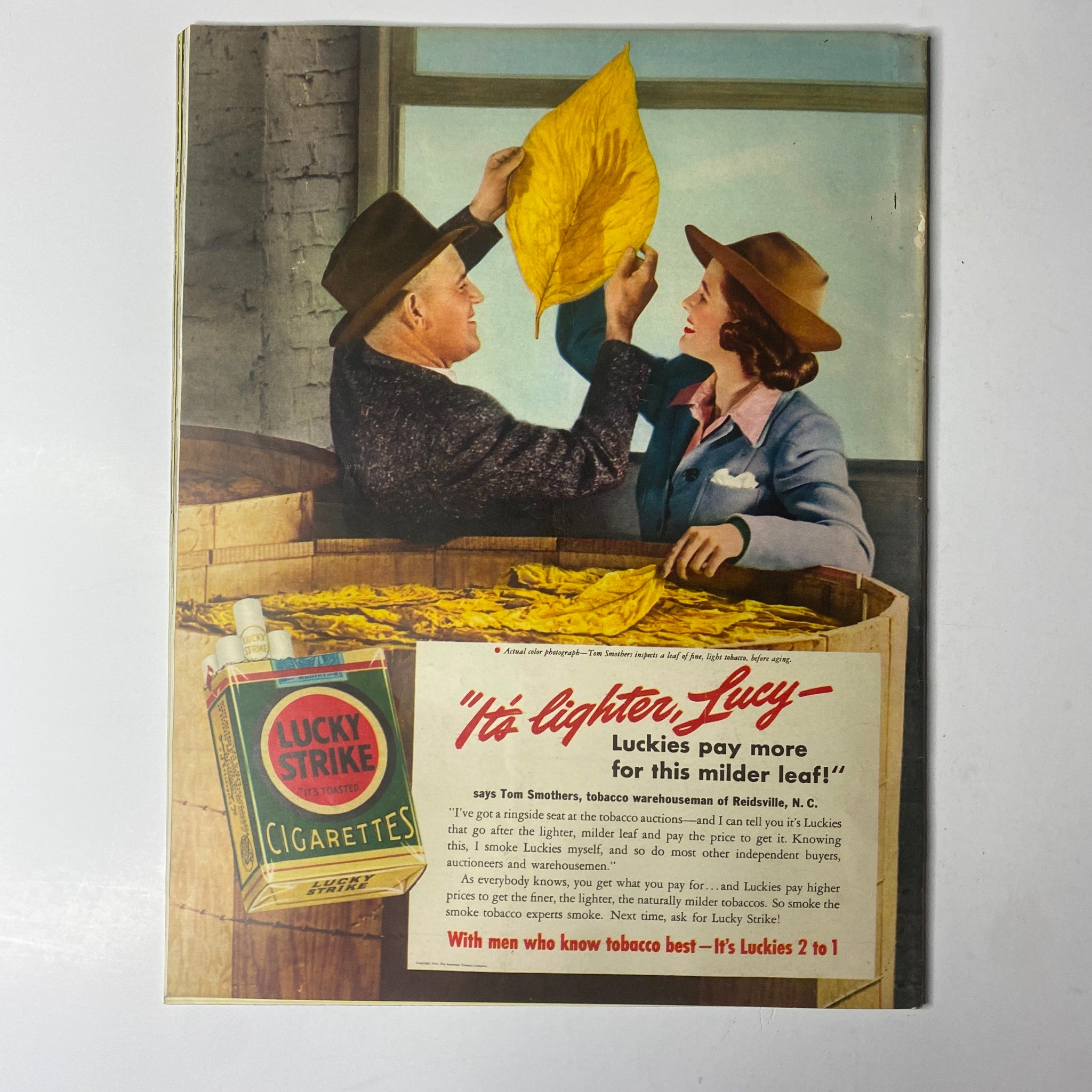An advertisement from Look Magazine June 3, 1941, featuring a couple inspecting tobacco leaves, promoting Lucky Strike cigarettes.