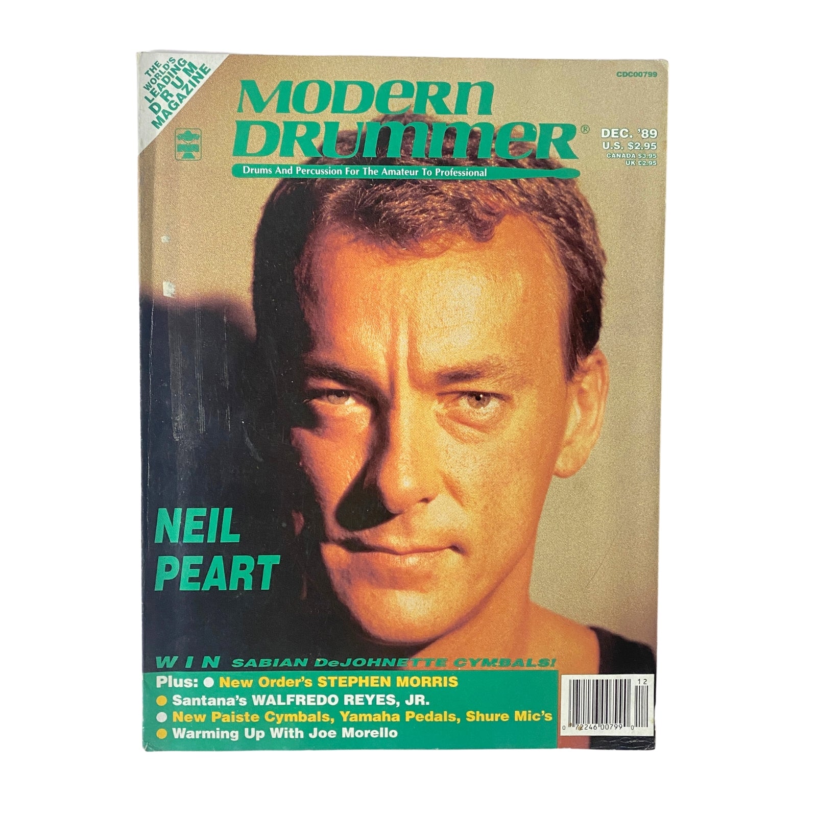 Modern Drummer Magazine December 1989 featuring Neil Peart on the cover. The magazine highlights drumming techniques and includes features on notable drummers like Stephen Morris and Walfredo Reyes, Jr. The issue is presented in good condition with a plastic protective cover.