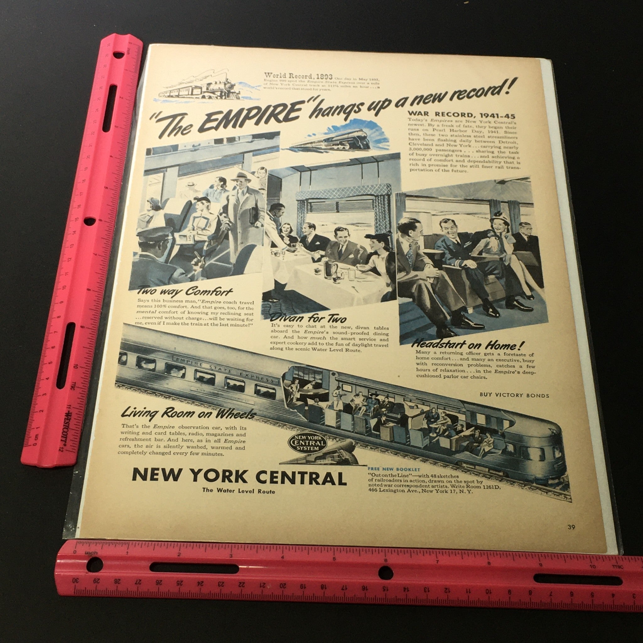 Front view of the 'VTG 1941-1945 New York Central System Empire Trains Print Ad' featuring the text and vibrant imagery showcasing the elegance of train travel alongside a ruler for size reference.