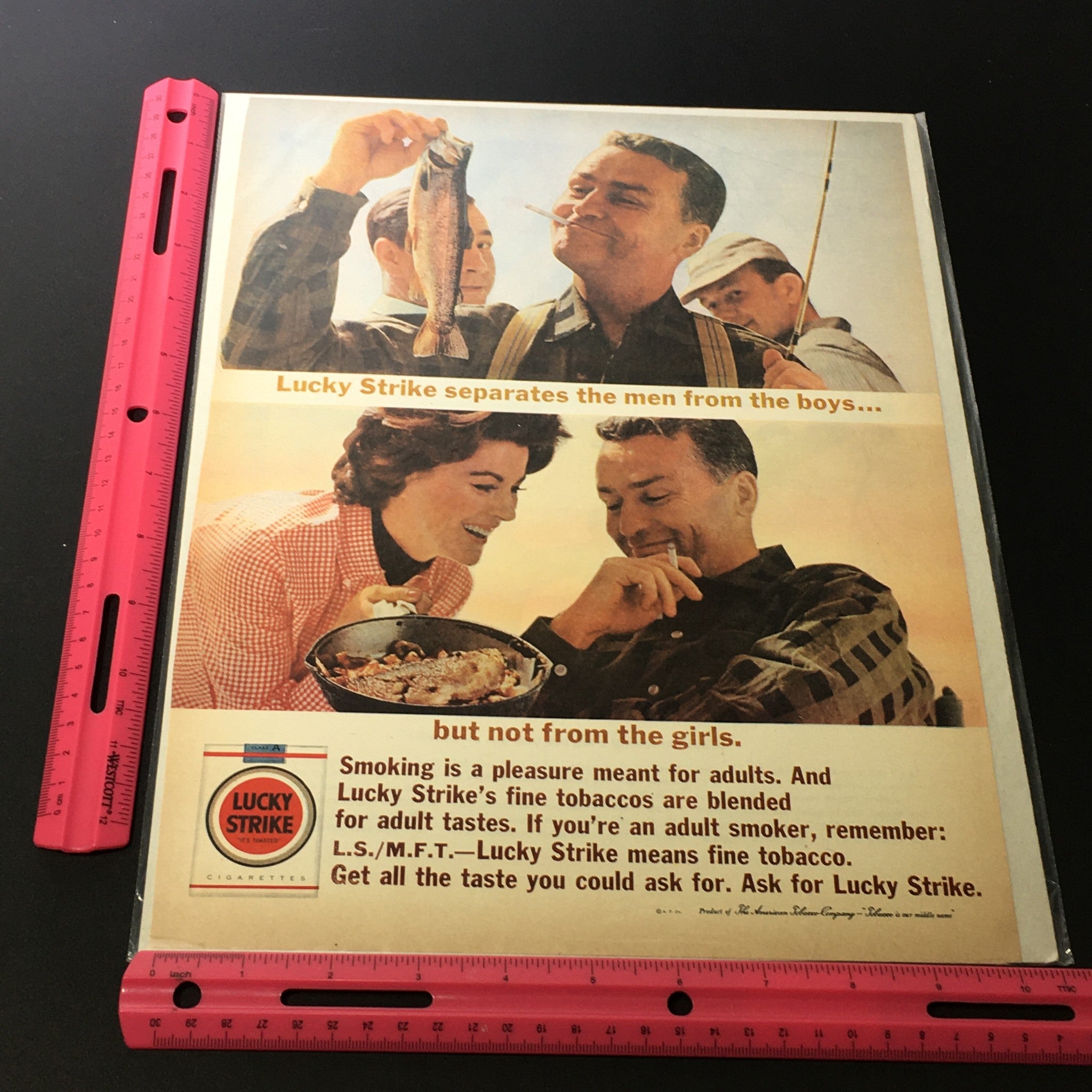 VTG 1940 The American Tobacco-Company Lucky Strike Cigarettes Print Ad showcasing a man holding a fish and enjoying a meal with another person, illustrating the slogan 'Lucky Strike separates the men from the boys but not from the girls.'