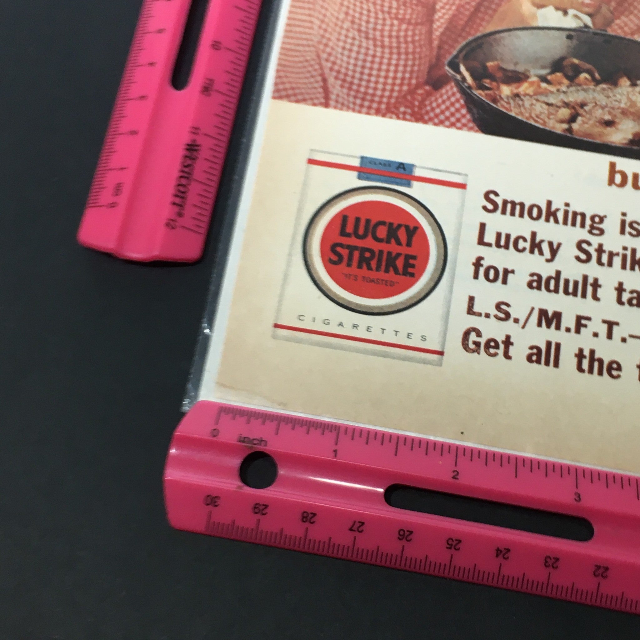 Close-up of VTG 1940 The American Tobacco-Company Lucky Strike Cigarettes Print Ad featuring the Lucky Strike logo and text emphasizing smoking as an adult pleasure.