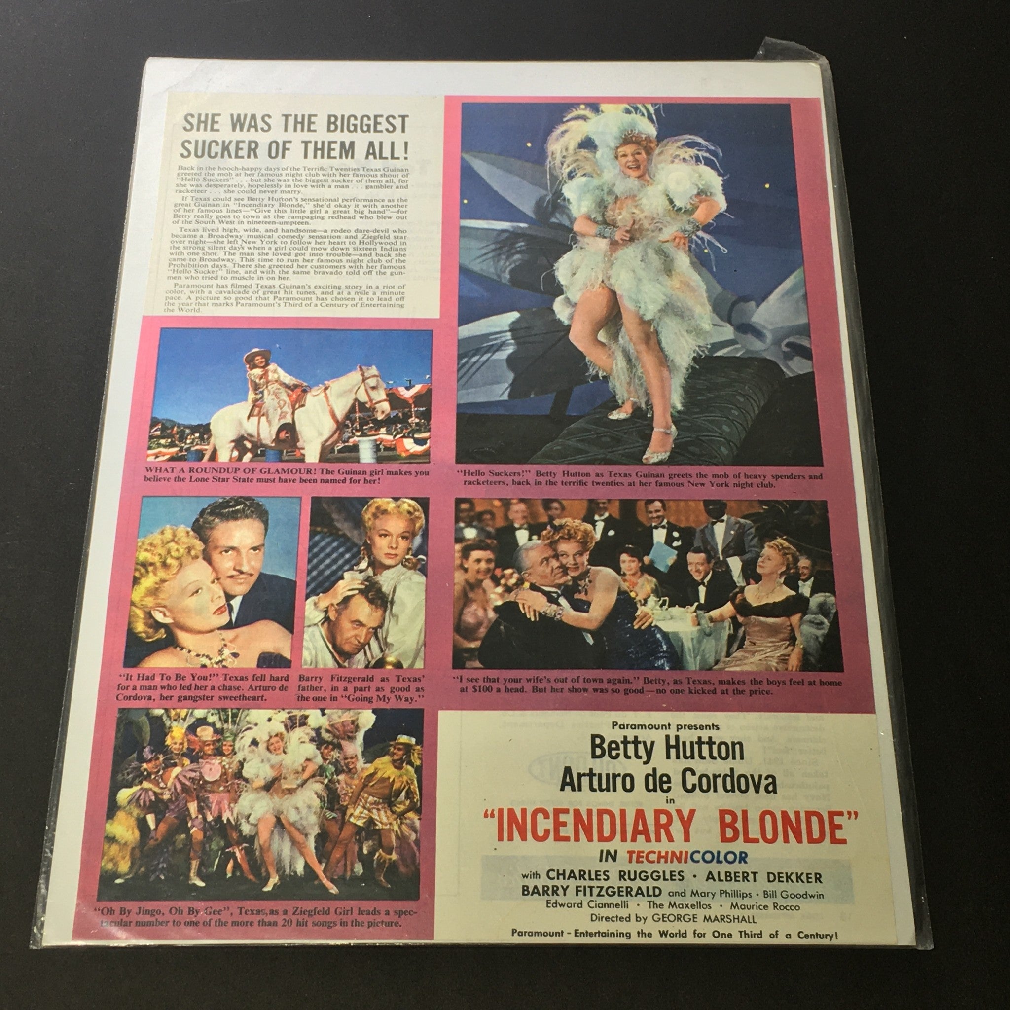 Vintage 1945 Paramount print ad featuring Betty Hutton and Arturo de Cordova in Incendiary Blonde, showcasing classic Hollywood style with vibrant images and typography.