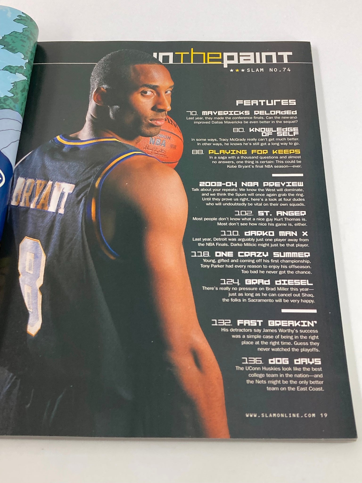 Image of Kobe Bryant on a page within the December 2003 Slam Magazine, highlighting his basketball prowess and list of features from the issue.
