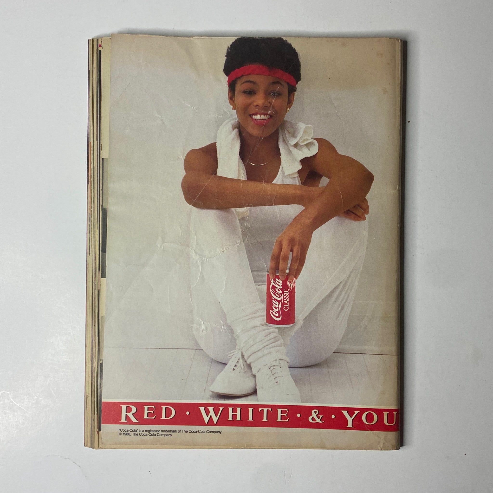 Back cover of Ebony Magazine July 1986 featuring a stylish model promoting Coca-Cola with a vibrant and fashionable look. Highlights the magazine's focus on culture and lifestyle.