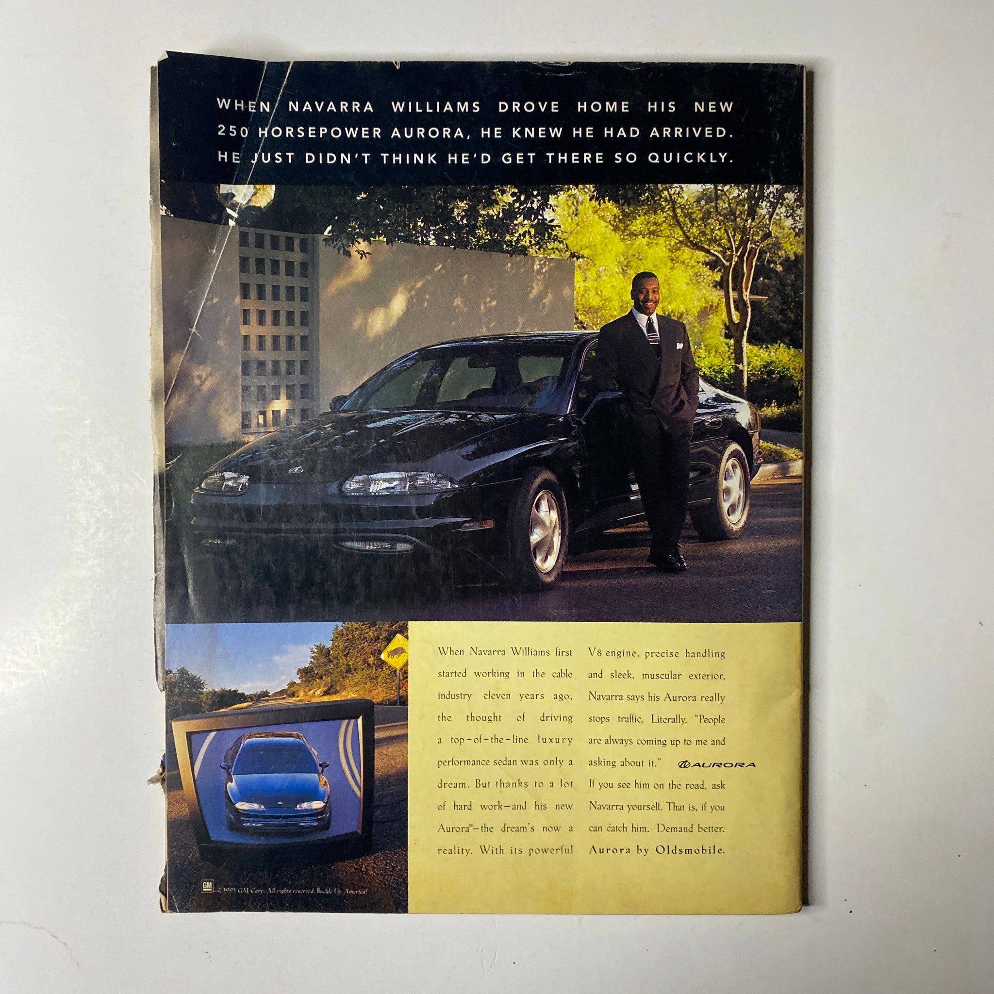 Back cover of Ebony Magazine May 1996 displaying an advertisement for a new car alongside a man, reflecting on themes of success and pride. Covering iconic personalities like Shaquille O'Neal and family.