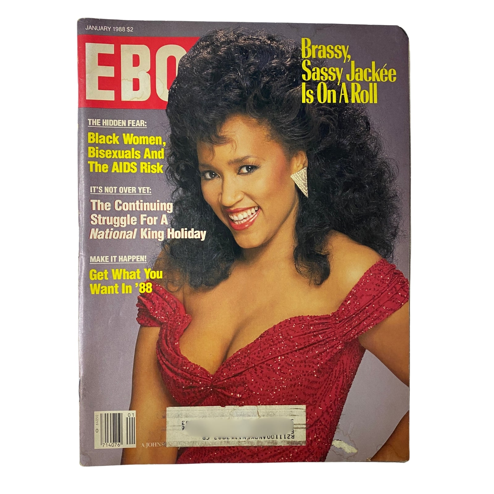 Ebony Magazine January 1988 cover featuring Jackée Harry, showcasing her vibrant personality in a striking red dress with curly hair, highlighting her status as a beloved television star.