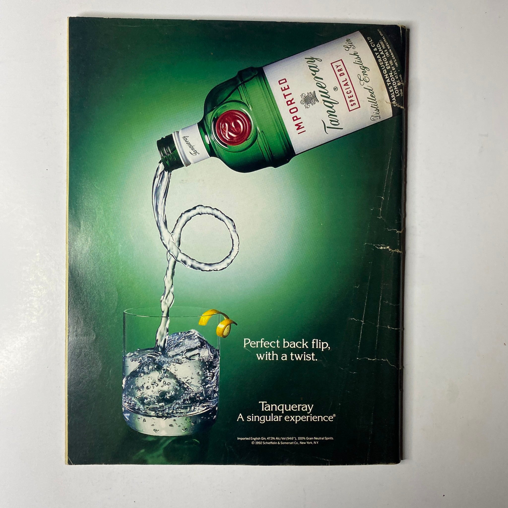 Ebony Magazine January 1994 featuring a unique Tanqueray advertisement showcasing a bottle pouring into a glass with ice, conveying a refreshing drink experience.