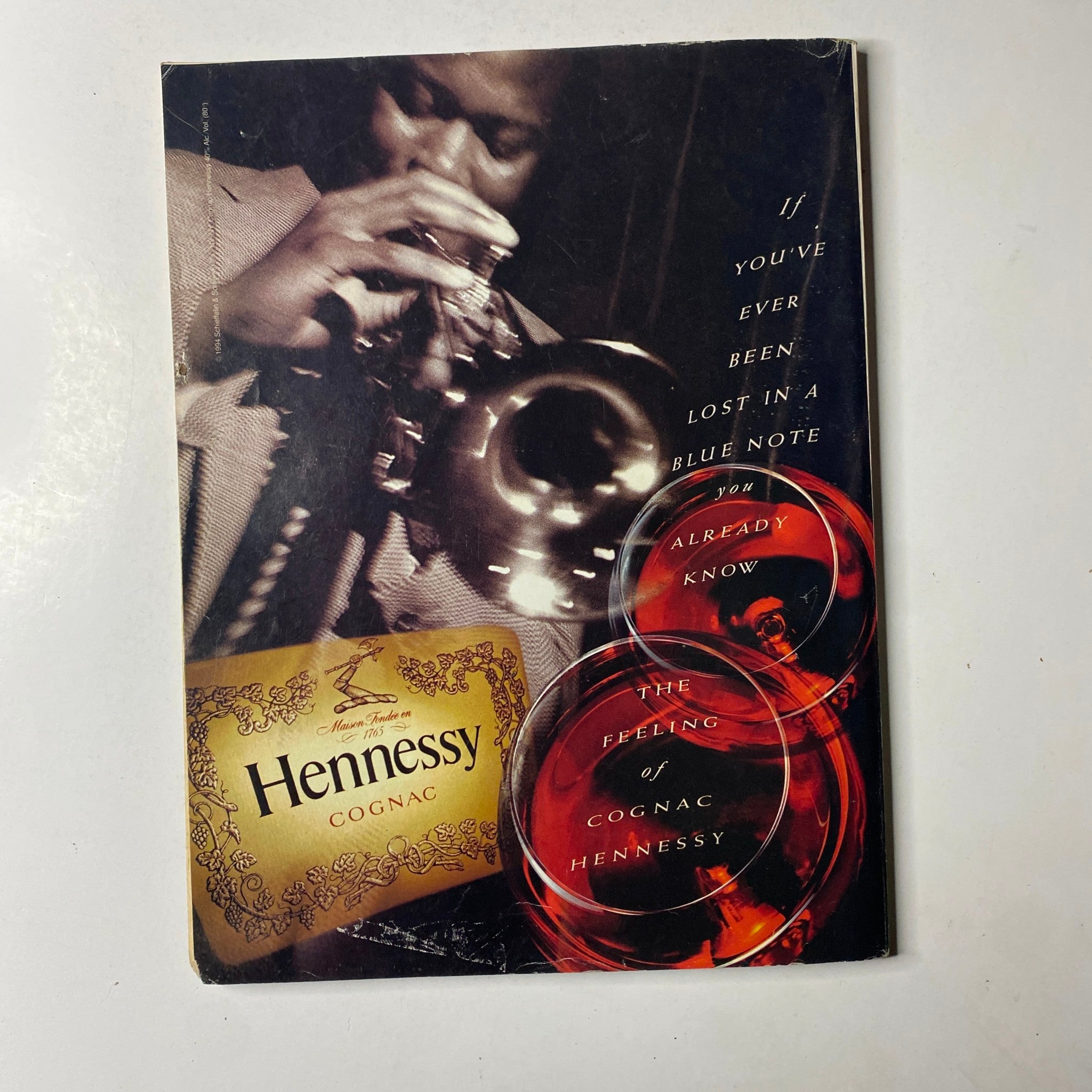 Promotional Hennessy Cognac advertisement featuring a man playing the trumpet, symbolizing cultural richness in relation to the features of Ebony Magazine October 1996.